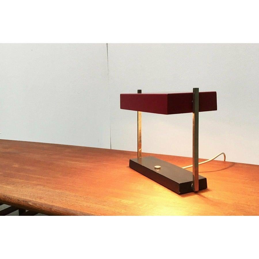 Mid century table lamp from Hillebrand Leuchte.

A minimalist design in shape and color. The reflector umbrella is flat and rectangular, which makes it appear very objective and timeless. The coloring further supports this. The base is cuboid and