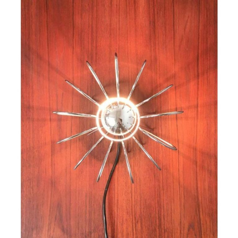Mid-Century table lamp with transparency.

The luminaire body is almost completely dissolved in wire elements. These form the contour and are radially arranged around the inner cylinder with the frame. European Plug (up to 250V).The wiring of this