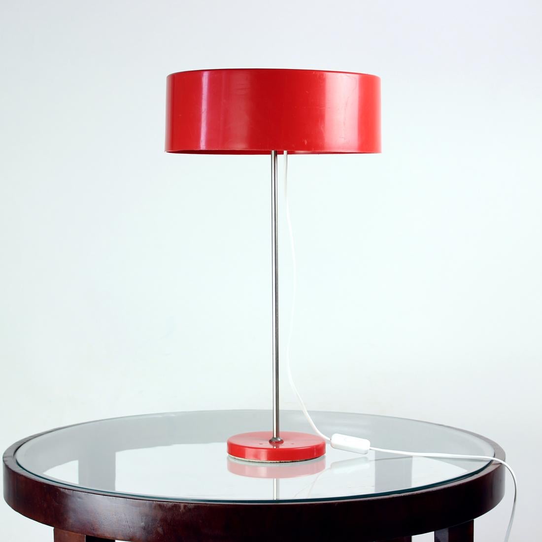 Beautiful mid-century table lamp produced by Kamenicky Senov in Czechoslovakia in 1970s. The lamp is a typical Space age era design using the typical materials and design features. The shiels and base are made of red plastic. The design is elegant,