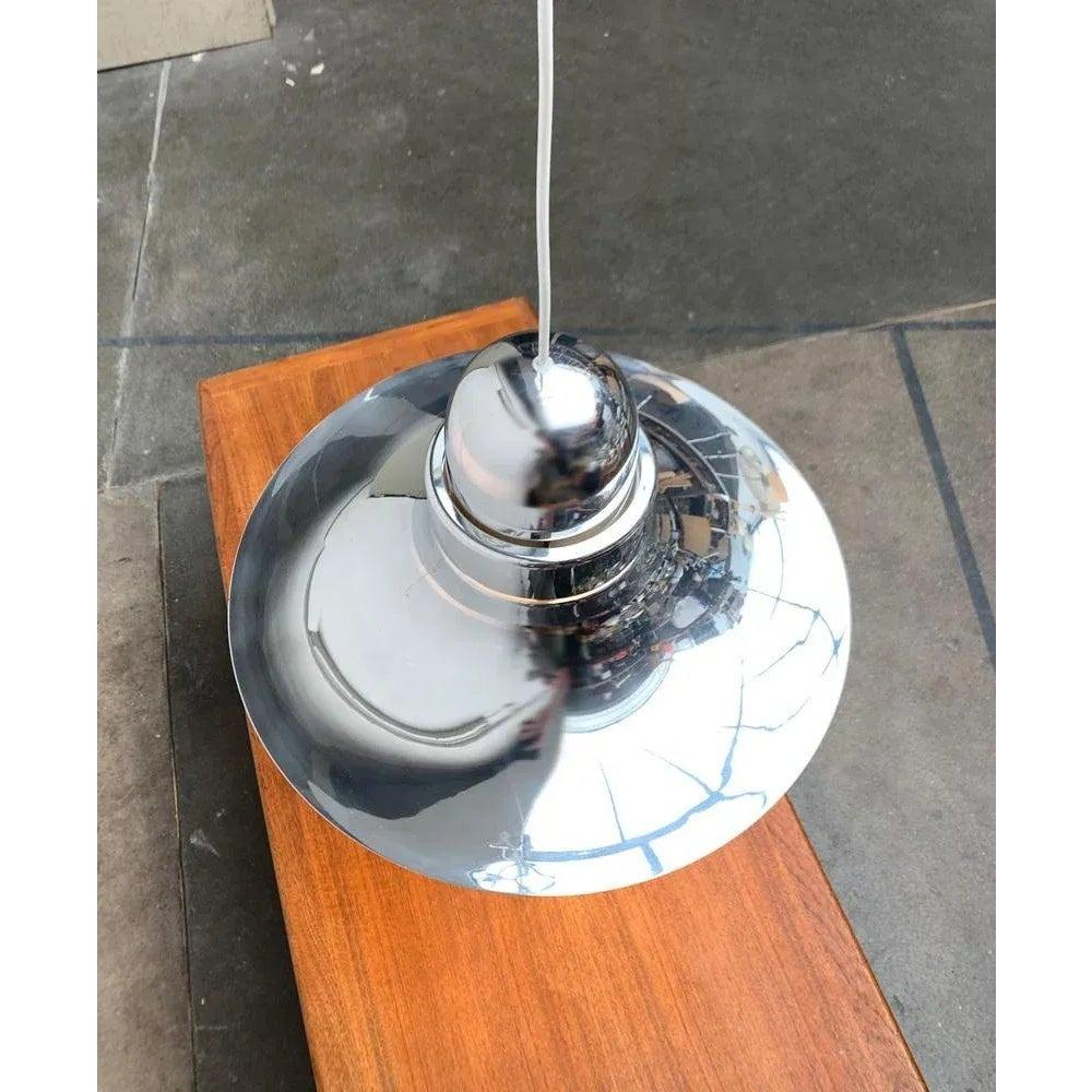 Imponente lampada a sospensione A Space AGE con superficie riflettente.

Il design convince per le sue dimensioni e le sue curve eleganti. L'ombrello si allarga verso il basso fino a diventare parallelo al pavimento. In cima termina con una