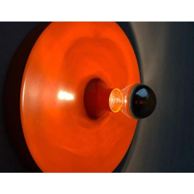 Wall or ceiling lamp in the classic water drop design by Kontakt-Werkstätten (later Staff).

Striking lamp from the 1960s/1970s in an orange tone characteristic for the time. In the middle of the luminaire body, the version for screwing the lamp is