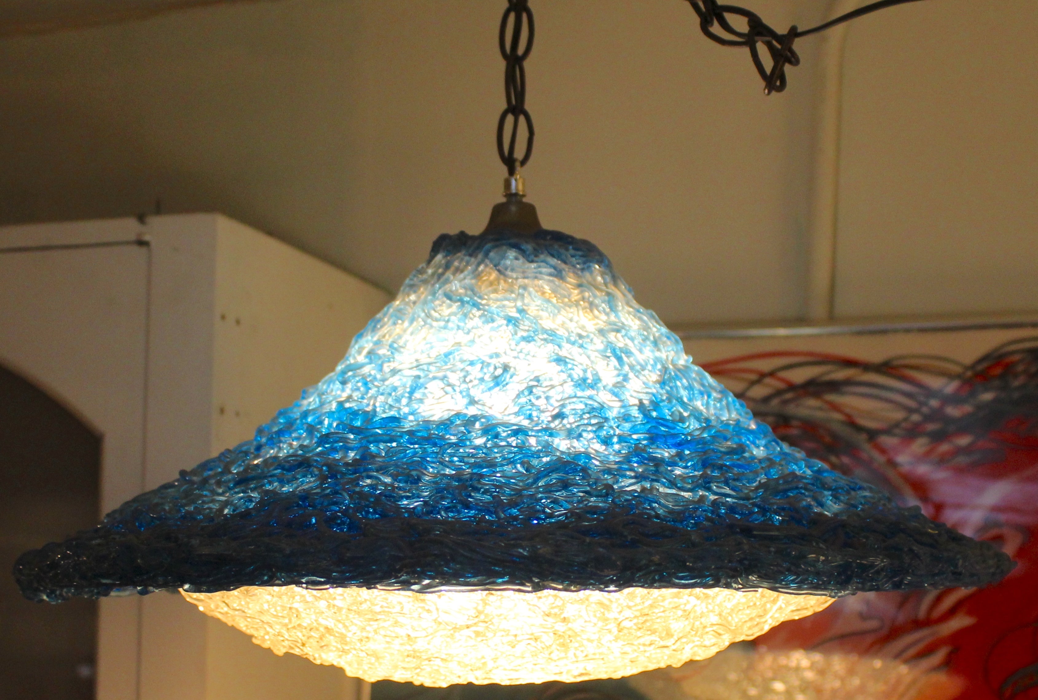 Vintage circular pendant made of stands of lucite in blue and white, giving the single bulb a warm glowing shade.
Please confirm location NY or NJ