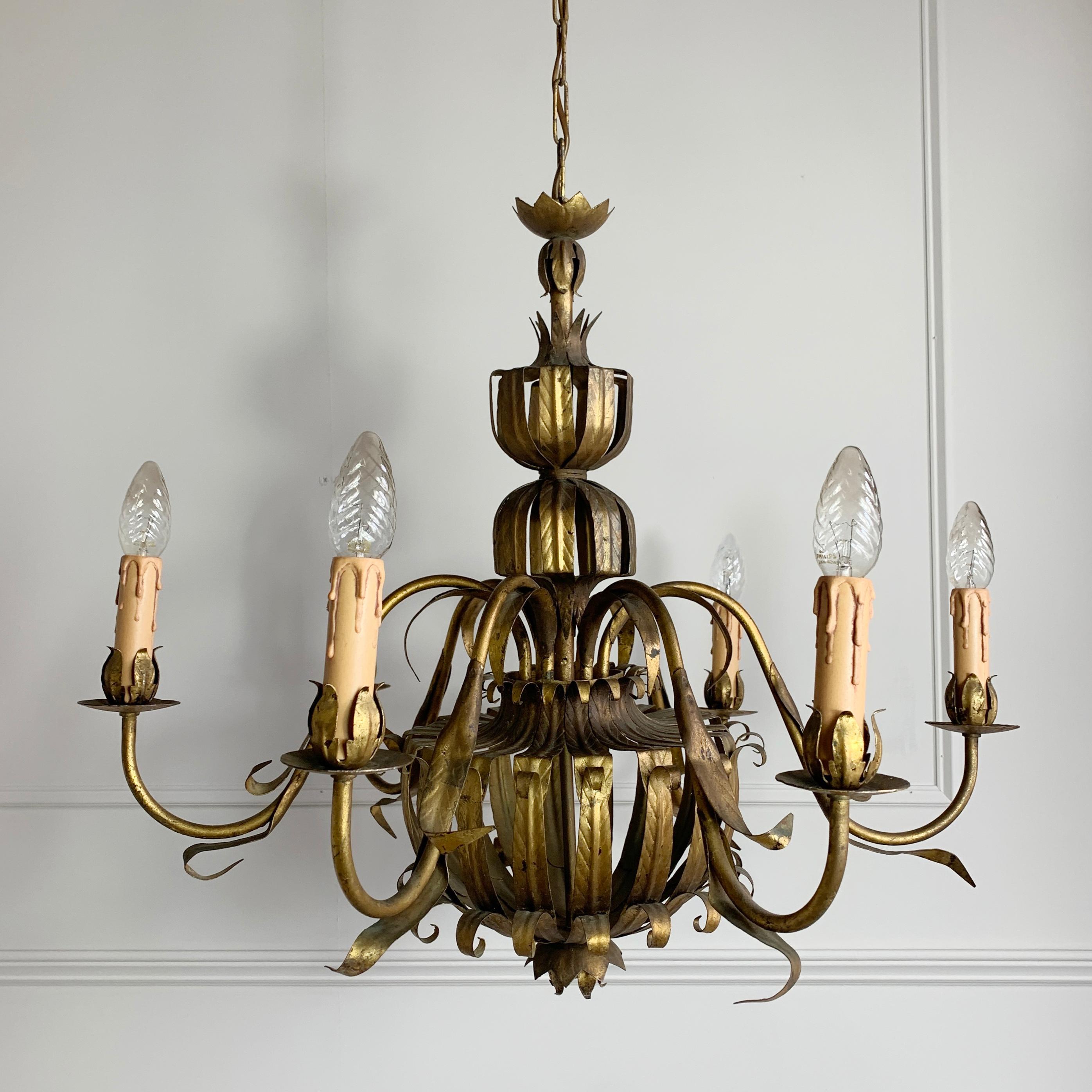 Spanish Mid Century gilt, handcrafted metal chandelier
Attributed to Ferro art, the characteristics of the flower bud lamp cups and the linear detail on the leaves is consistent to their design
This is a large sized chandelier, featured a superb