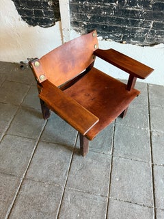 Mid century Spanish leather sling wood lounge arm chair with brass accents