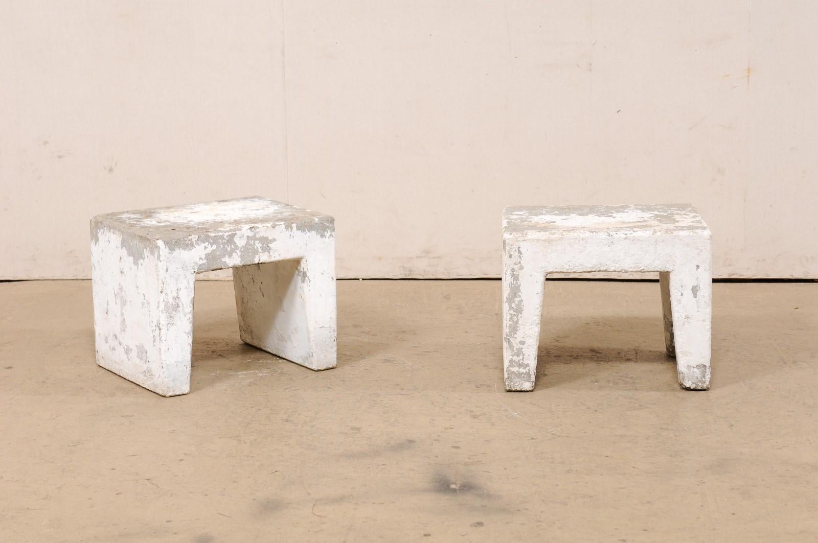 A Spanish pair of small concrete table stands from the Mid-20th Century. These midcentury concrete risers from Spain have been designed in clean/modern lines, with flat rectangular-shaped tops, and each raised on a pair of legs which give the tables