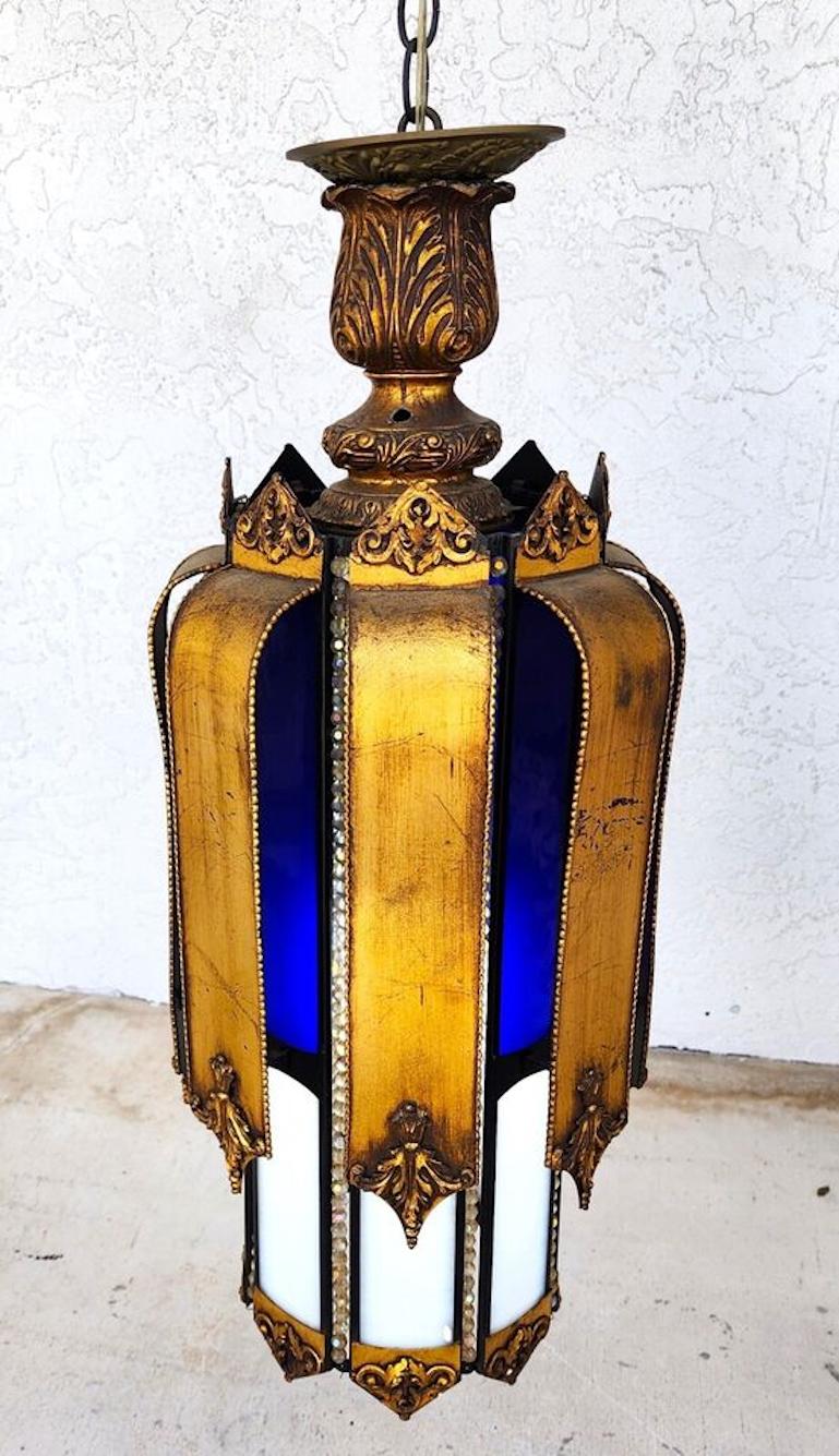For FULL item description click on CONTINUE READING at the bottom of this page.

Offering One Of Our Recent Palm Beach Estate Fine Lighting Acquisitions Of A
Mid-Century Spanish Pendant Light Chandelier
With Cobalt Blue and White Stained Glass,