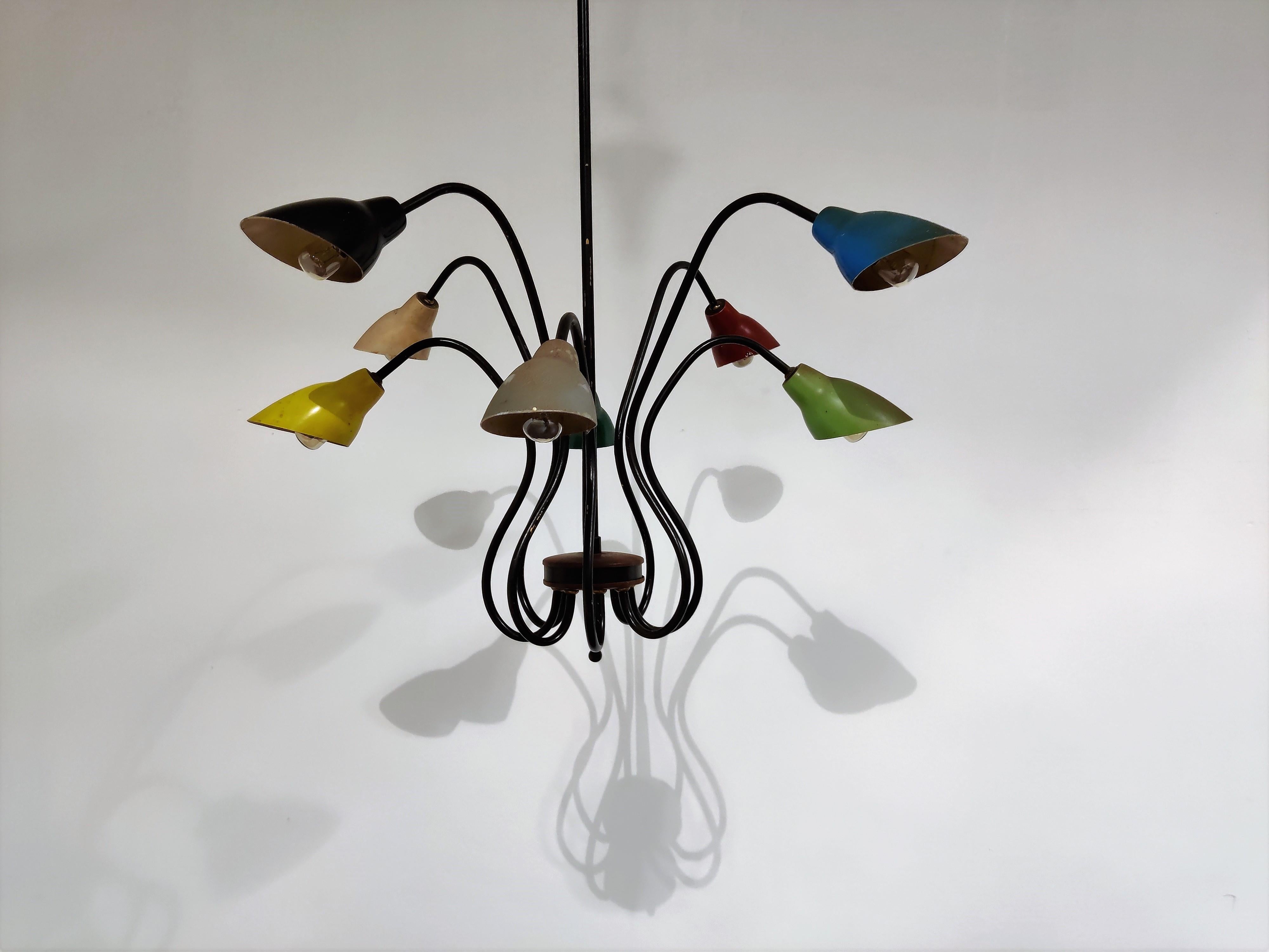 Beautiful midcentury 8-arm spider chandelier made from black lacquered brass and colored aluminum lamp shades.

This elegant chandelier is a rare find with the original untouched coloured lamp shades.

This type of lamps is mostly attributed to