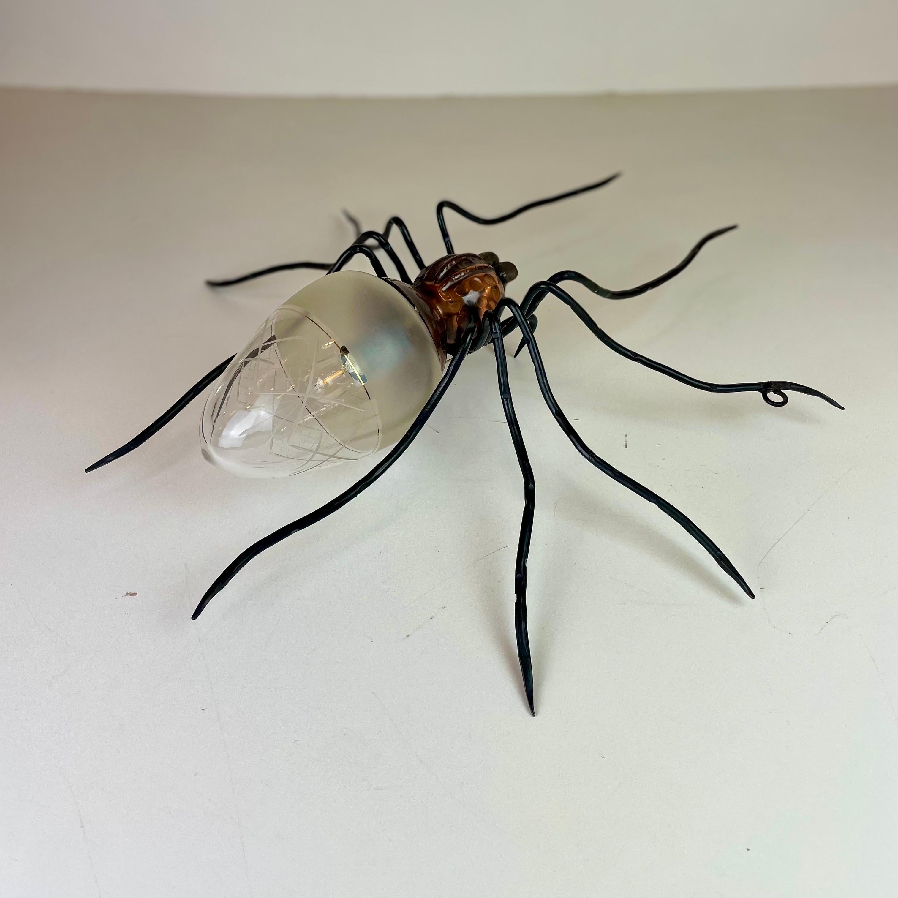 Apliques araña italianos de mediados de siglo en cobre, hierro fundido y vidrio artístico de los años 60.
Esta rareza es una típica lámpara de pared de exterior (cubierta) que solía montarse sobre la entrada de las puertas de las casas italianas de