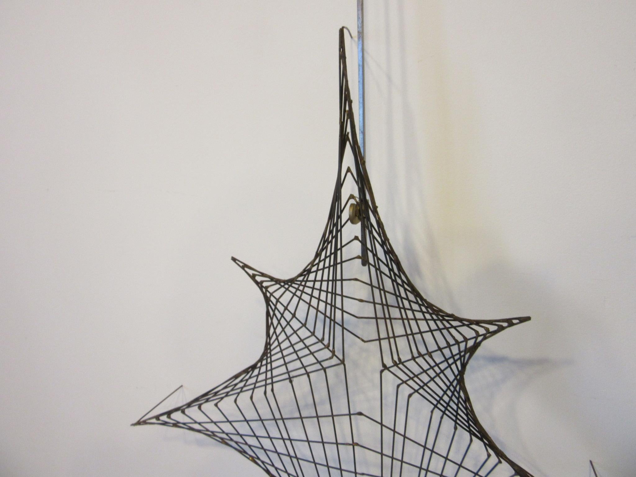 A very well crafted fine wire welded wall sculpture in the manner of a spider web while hanging it sits 3