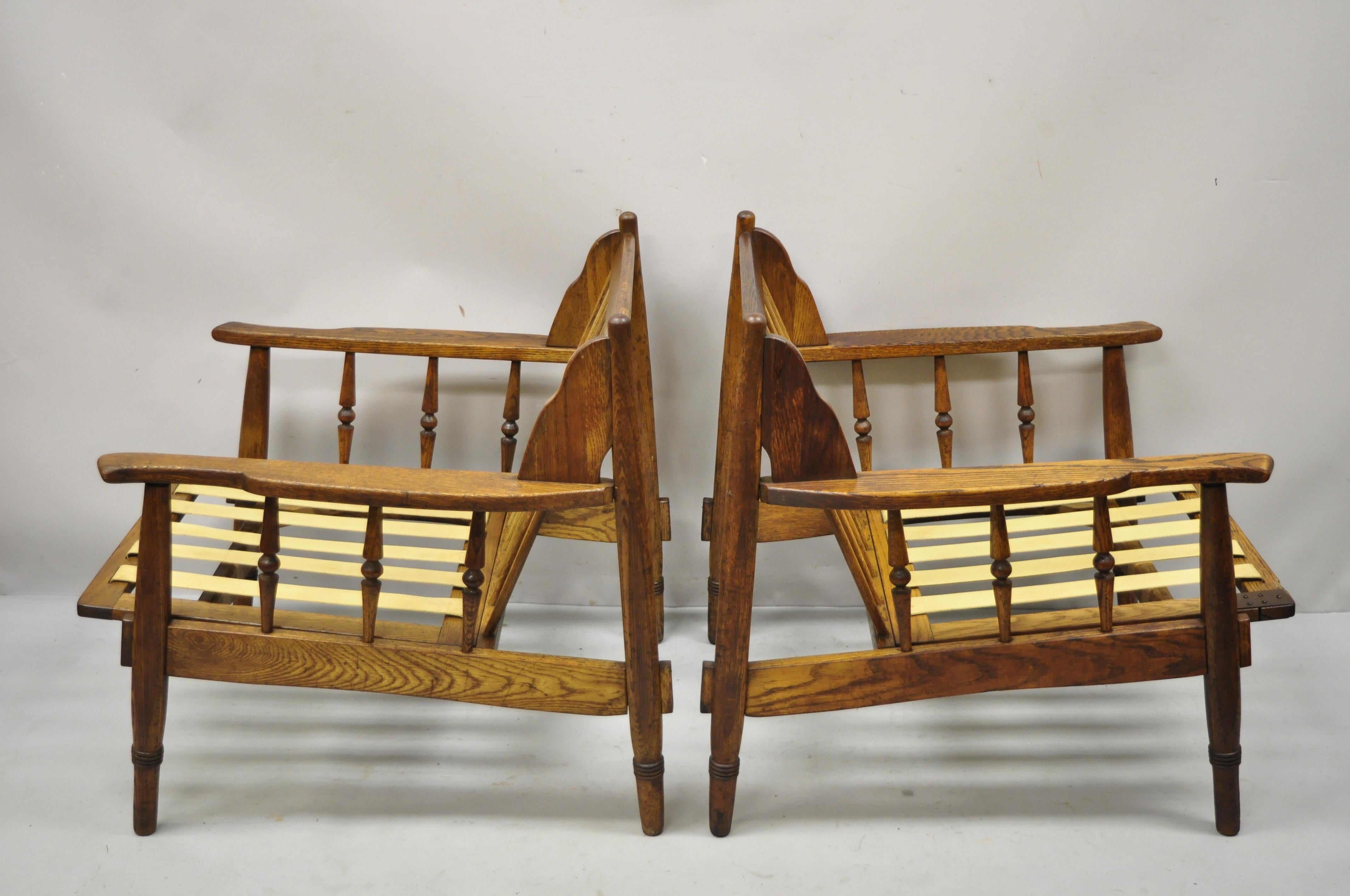 Mid-Century Modern spindle back oak wood danish style lounge club chairs - a pair. Item features spindle carved sides, solid oak wood frames, beautiful wood grain, very nice vintage pair, quality craftsmanship, great style and form. Circa Mid 20th