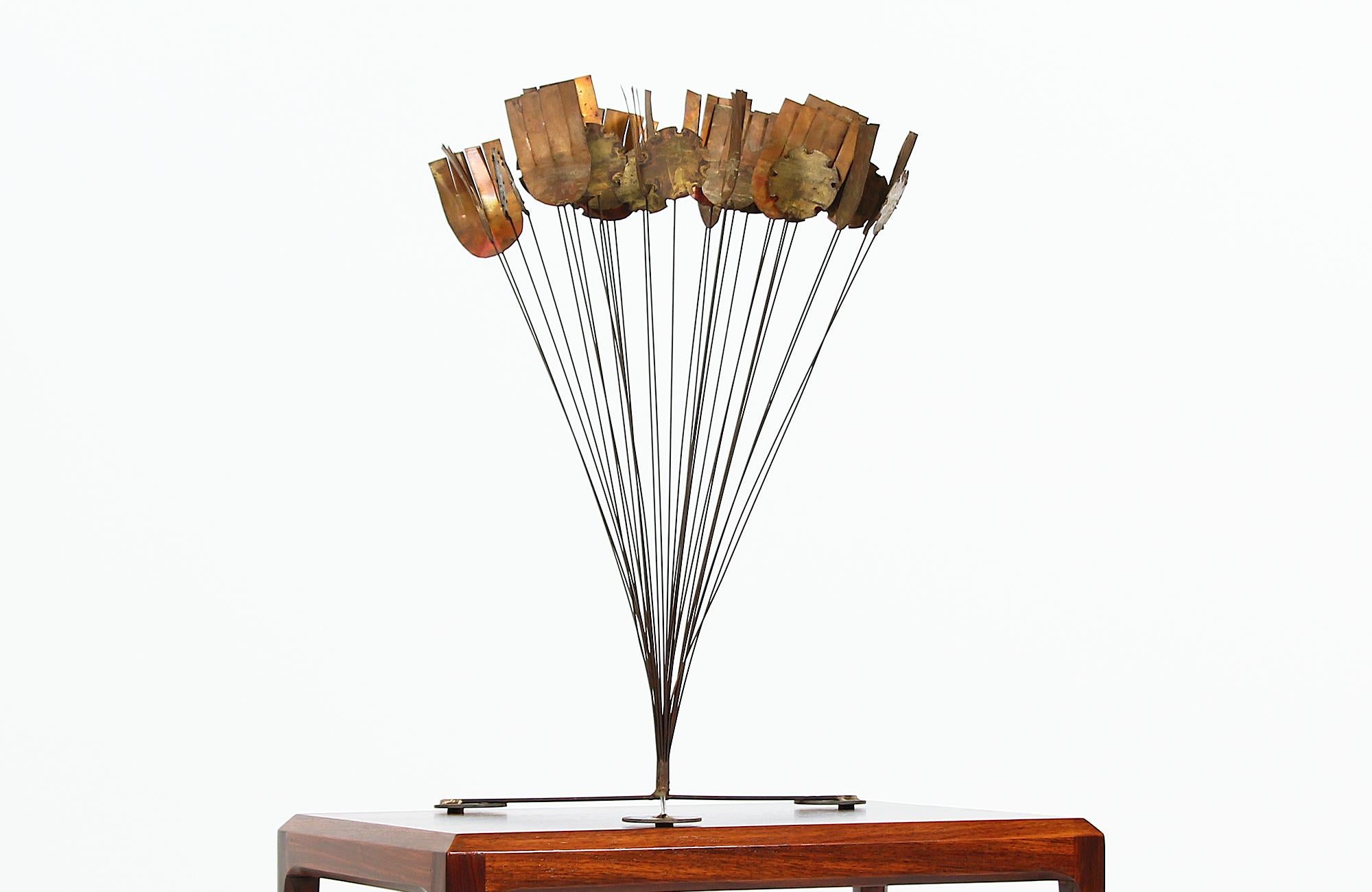 Stunning Brutalist sculpture designed and manufactured in the United States circa 1970s. This sculpture is the perfect example of midcentury Brutalist design featuring various brass shapes resembling flowers mounted atop thin metal rods. It is