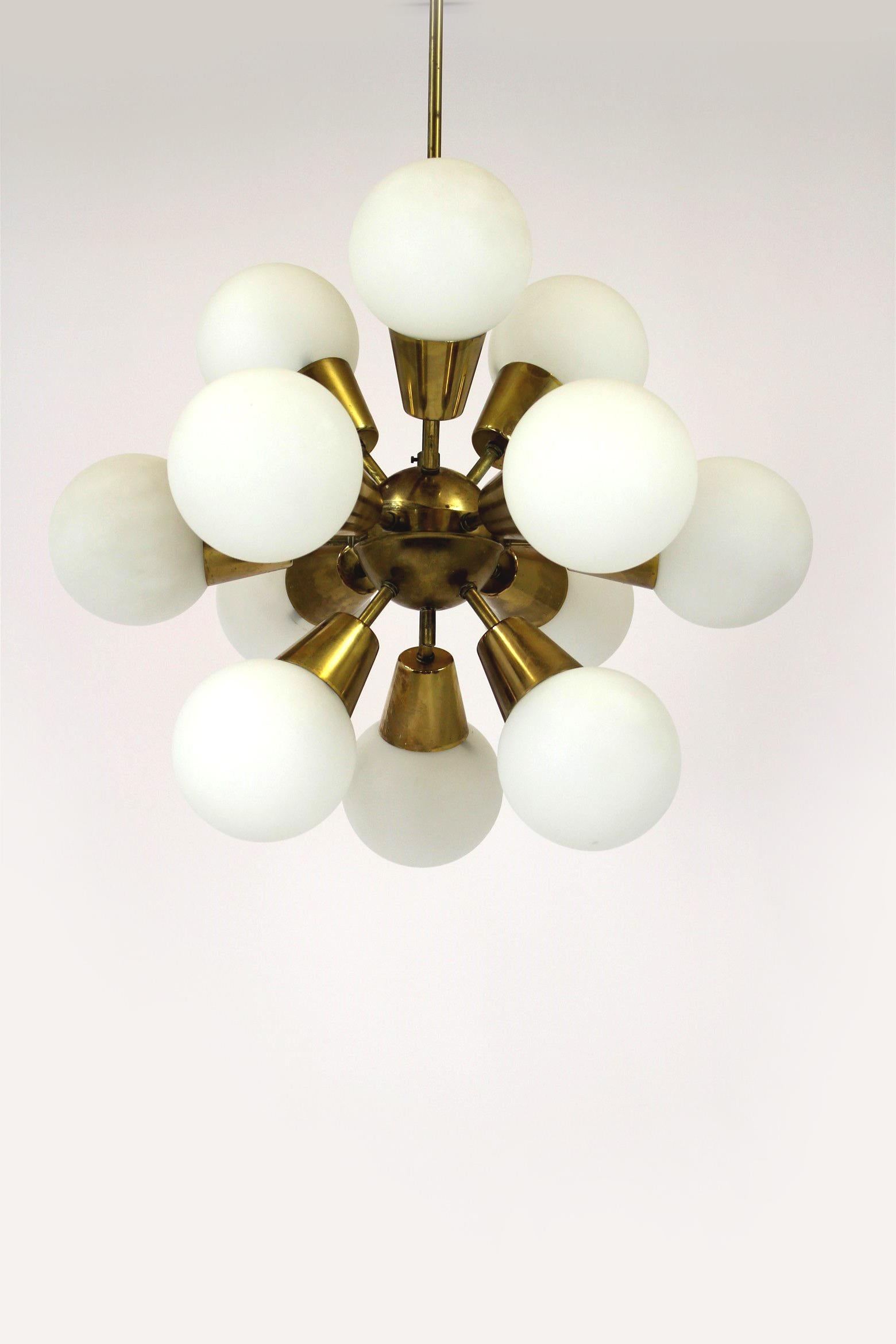 Mid-Century Sputnik chandelier. Made in former Czechoslovakia by Kamenický Šenov in the 1970s. Made of brass and milk glass, features 12 x E14 light fittings.
