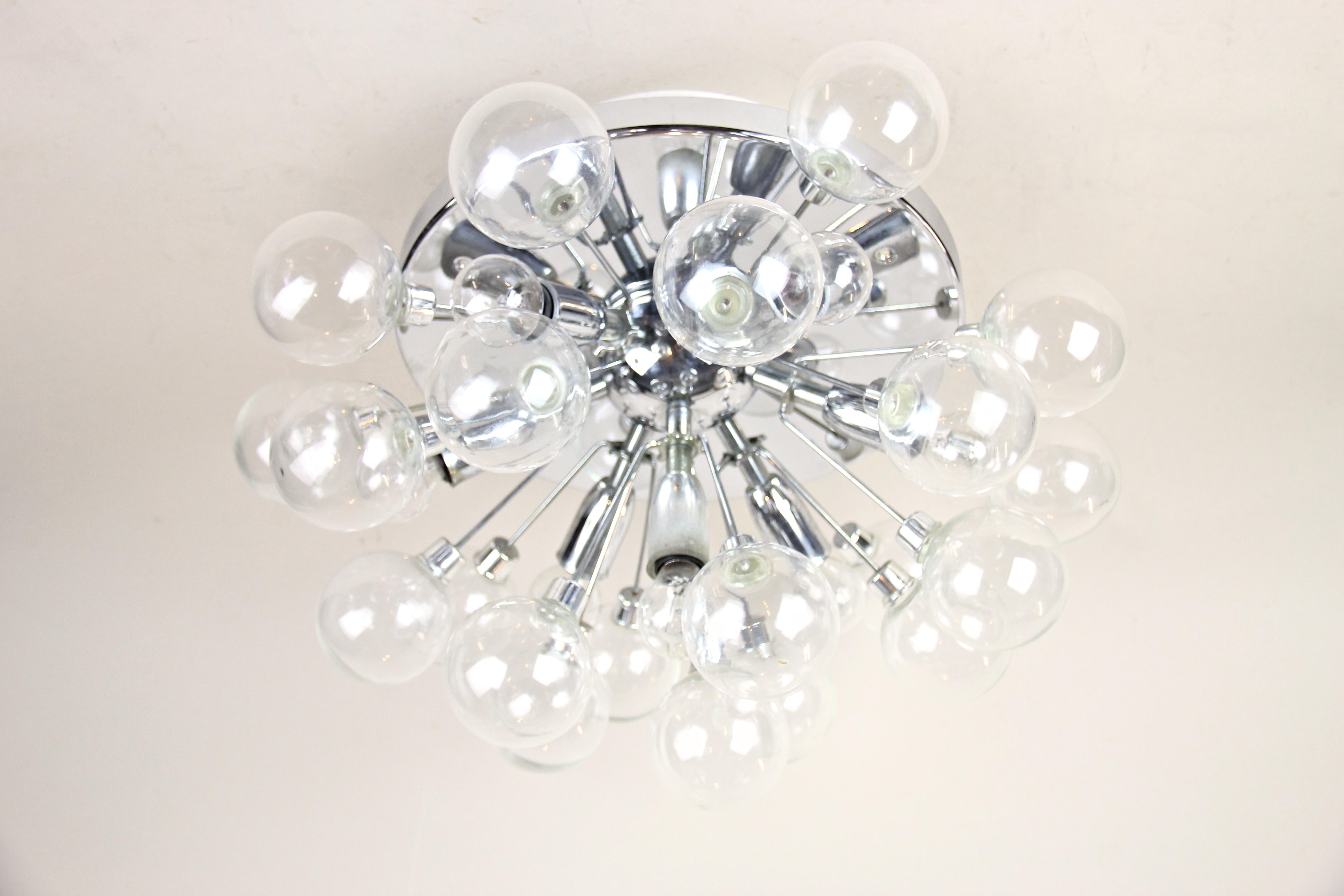 Marvelous midcentury Sputnik flushmount light out of Austria from circa 1960s. This designer ceiling light impresses with seven-light bulbs surrounded by twenty-one mouth blown glass spheres. In combination with the chromed surface this midcentury