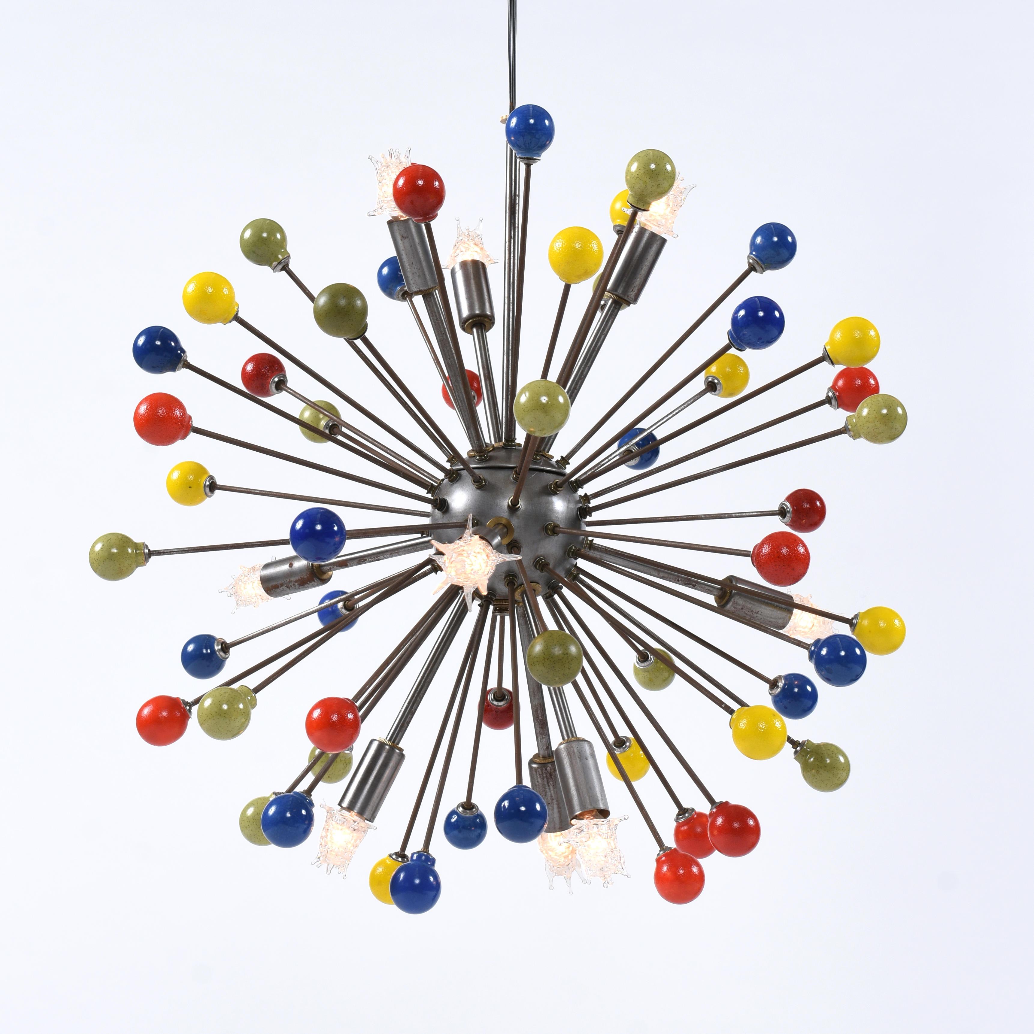 Every once in a while we get a piece that simply floors us. This is one of them. You’ve seen starburst pendant lamps before. I’m guessing that they’ve all been brass or chrome. Maybe you’ve seen the whimsical sunburst bulbs like the bulbs on this