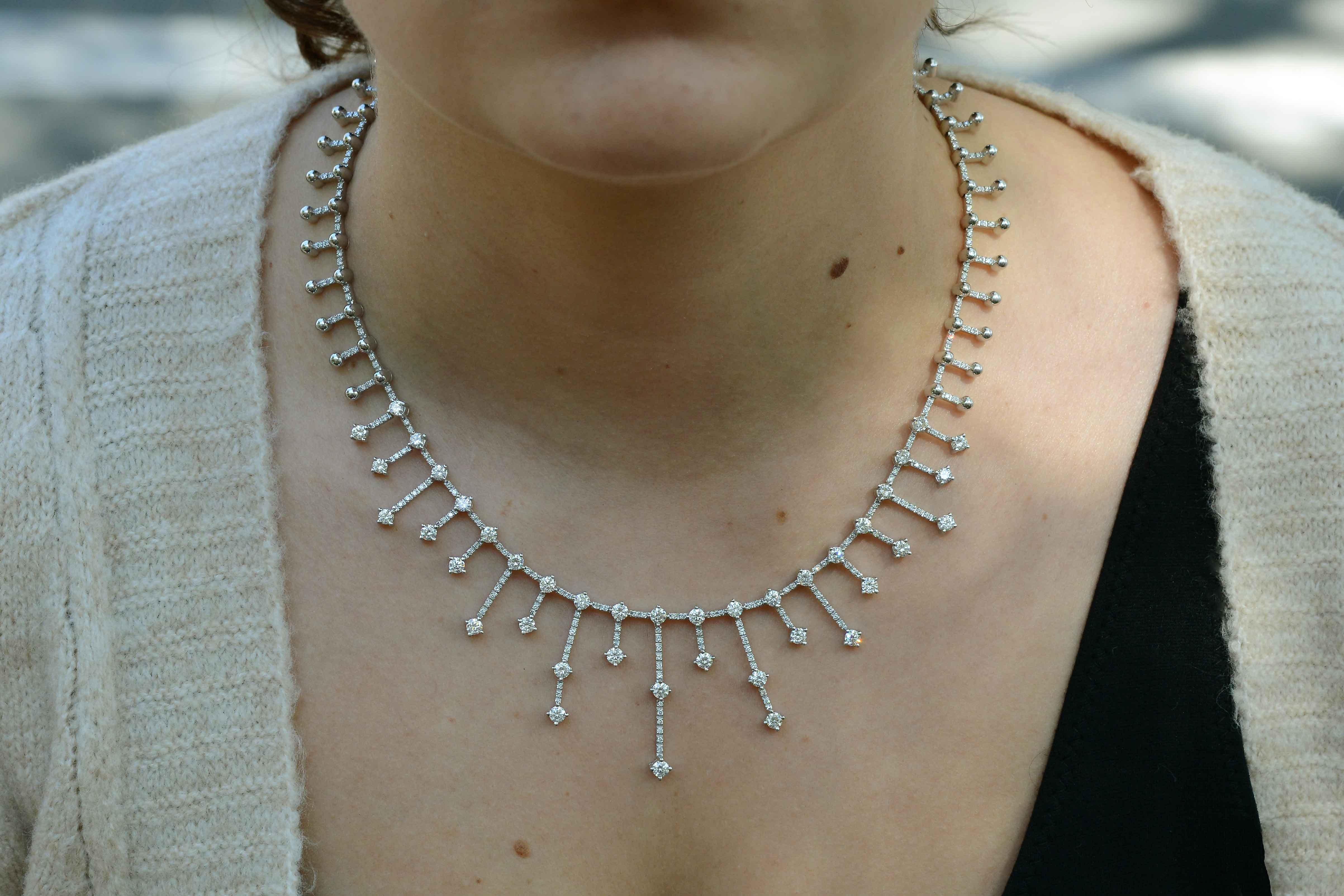A staggering mid-century diamond necklace. This unique piece displays rays of round brilliant cut diamonds that radiate on an 18k white gold backdrop. An elegant showstopper that drapes elegantly on your neck resembling a choker, but not a tight