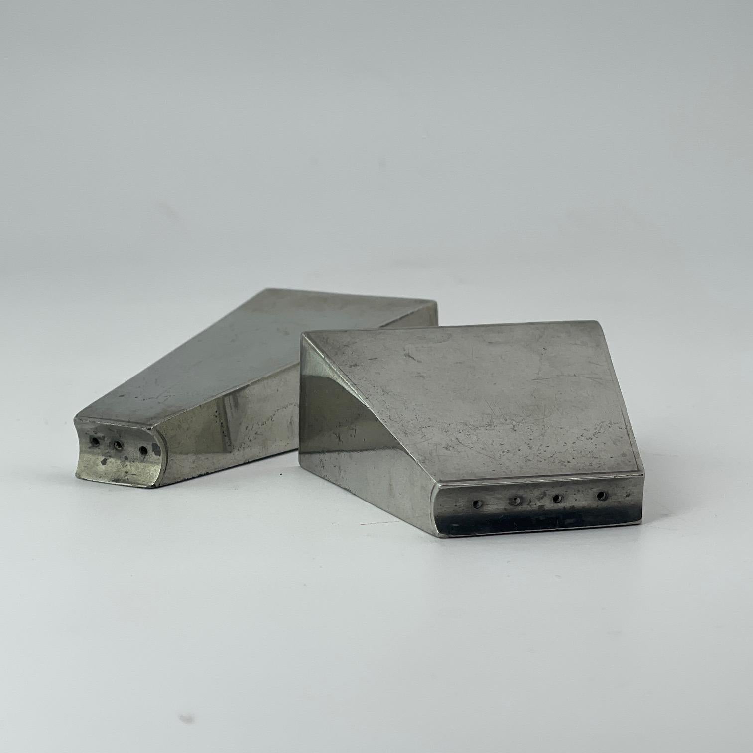 Patinated Pyramid Salt and Pepper Vessels. Design is attributed to Paul Evans. 

W 2 x 15/16 x 2 in
W 1.5 x 15/16 x 3 in