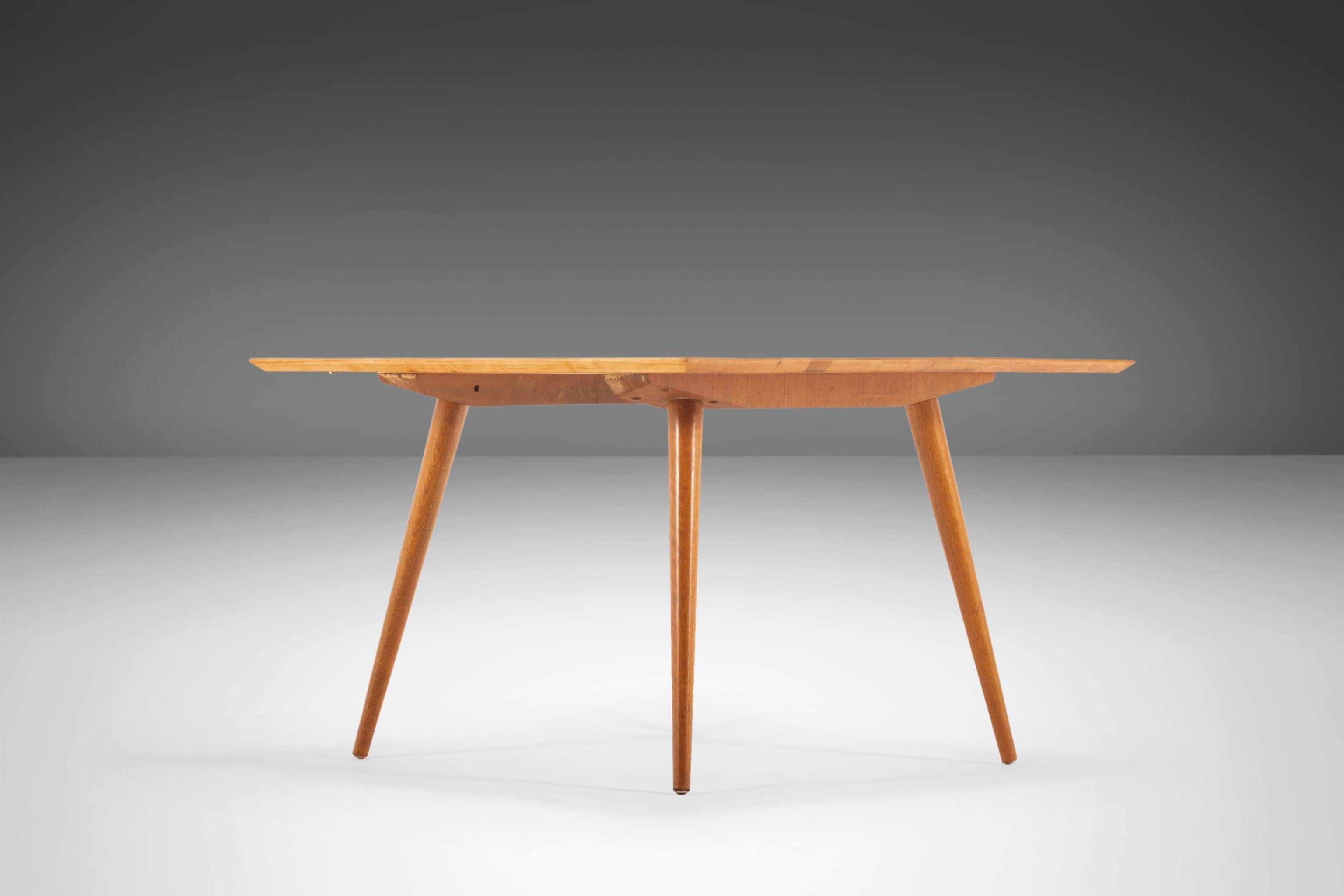 Iconic, minimal and absolutely stunning this coffee table designed by the visionary Paul McCobb for Planner Group is the quintessential archetype of American Modern design. Constructed of solid maple with exceptional wood grains, conical legs and