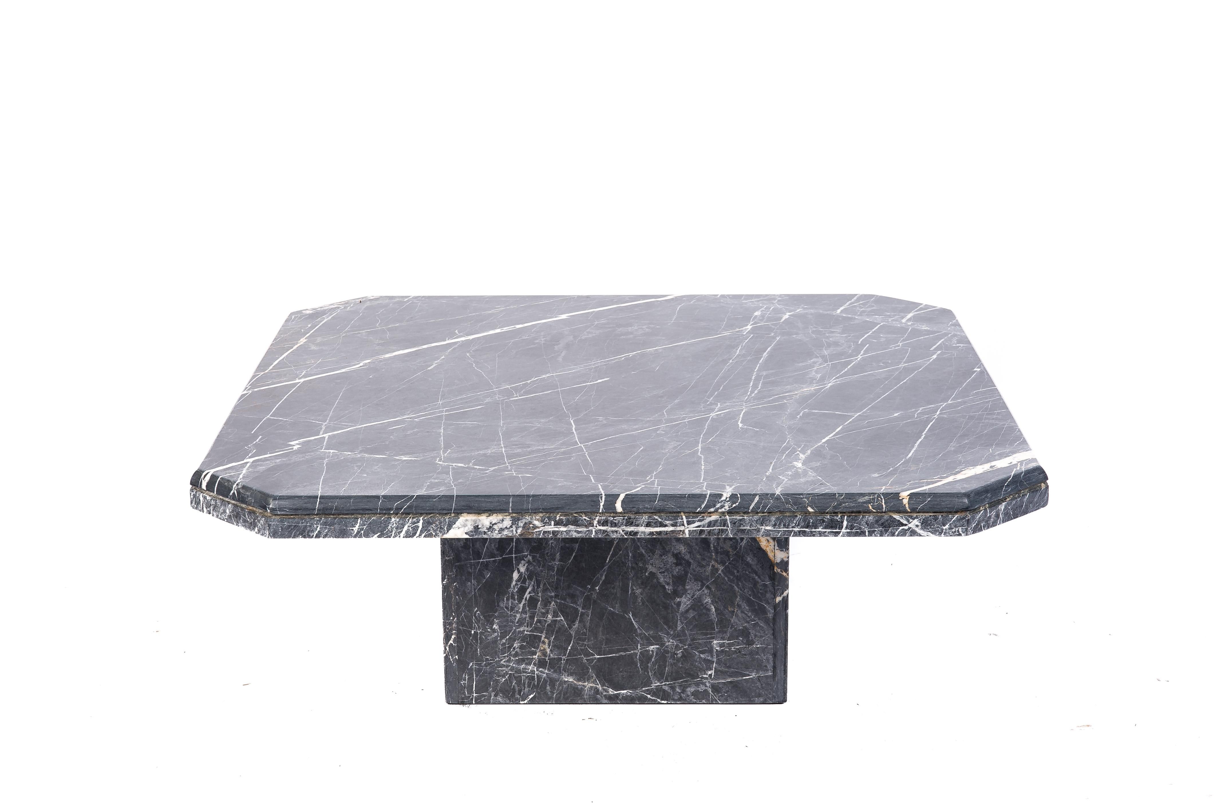 This beautiful marble coffee table was completely made in Noir saint Laurent black marble. It was made in France circa 1970. It has a square top with chamfered corners and a molded edge. It rests on a simple square marble base. The whole table was