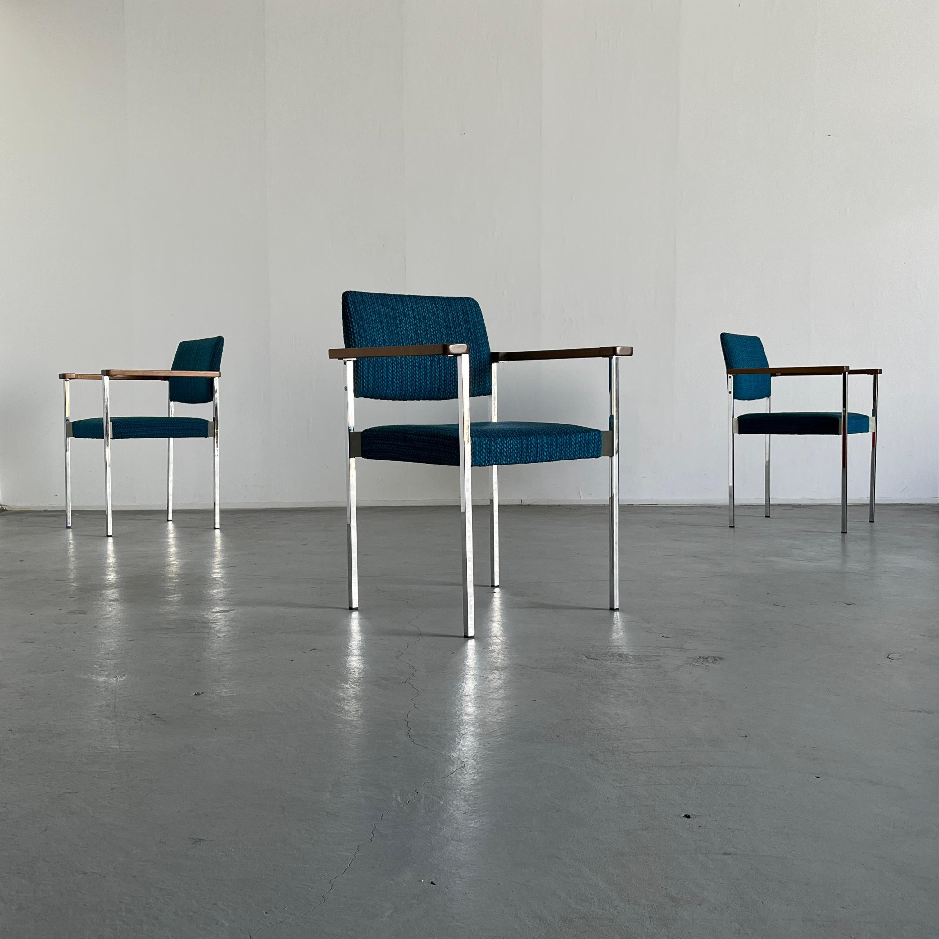 Mid-Century Modern stackable dining chairs or side armchairs with chrome frame, wooden armrests and amazing blue knitted upholstery. 
High production quality.

Original vintage condition with expected signs of age
Structurally excellent. Upholstery