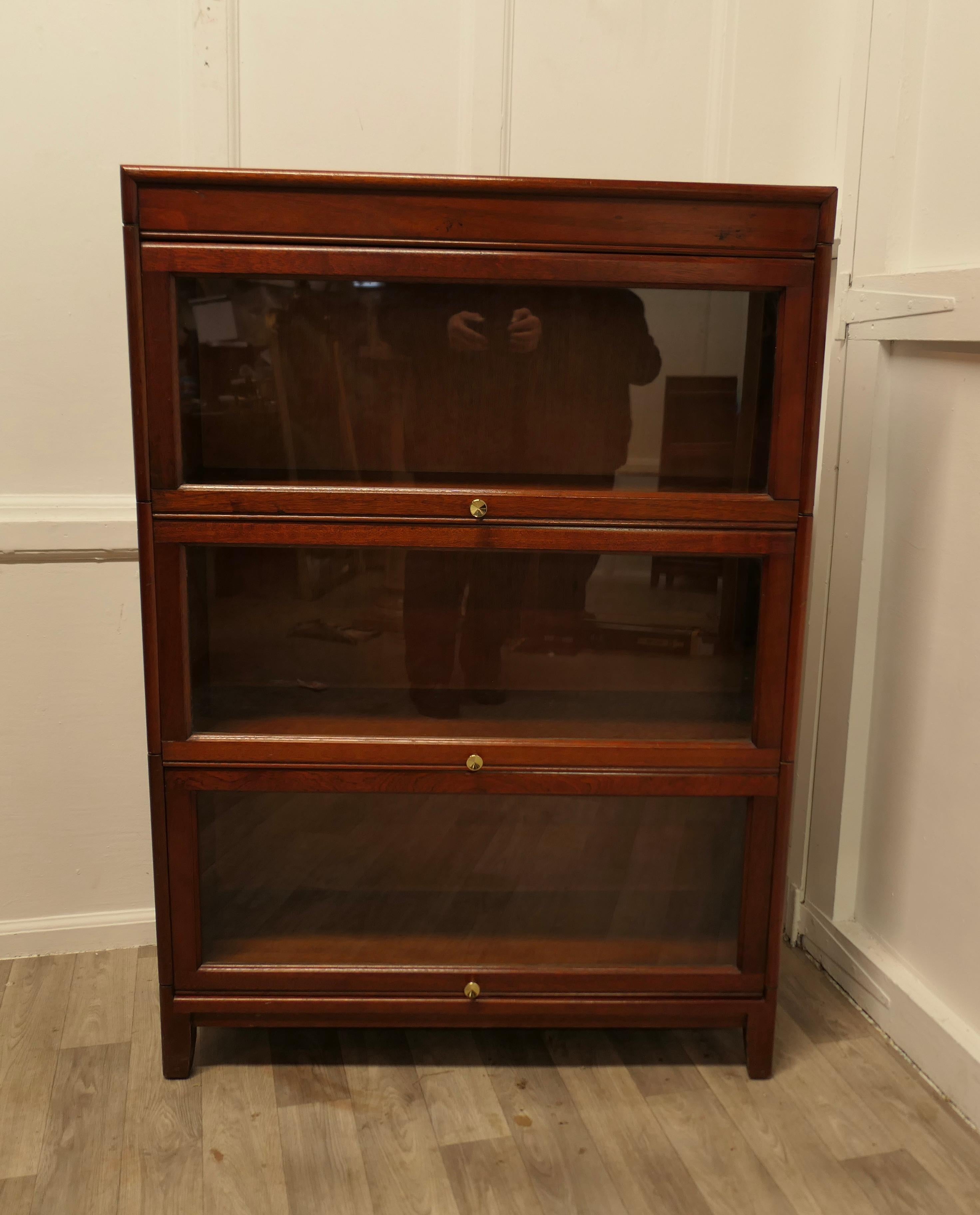 Mid Century Stacking Barristers Bookcase or Filing Cabinet

This is a good quality  Bookcase, all of the sections have glazed up and over door enclosing a 12” tall section
The Bookcase is in good sound condition it is 48” high, 34” wide and 12” deep