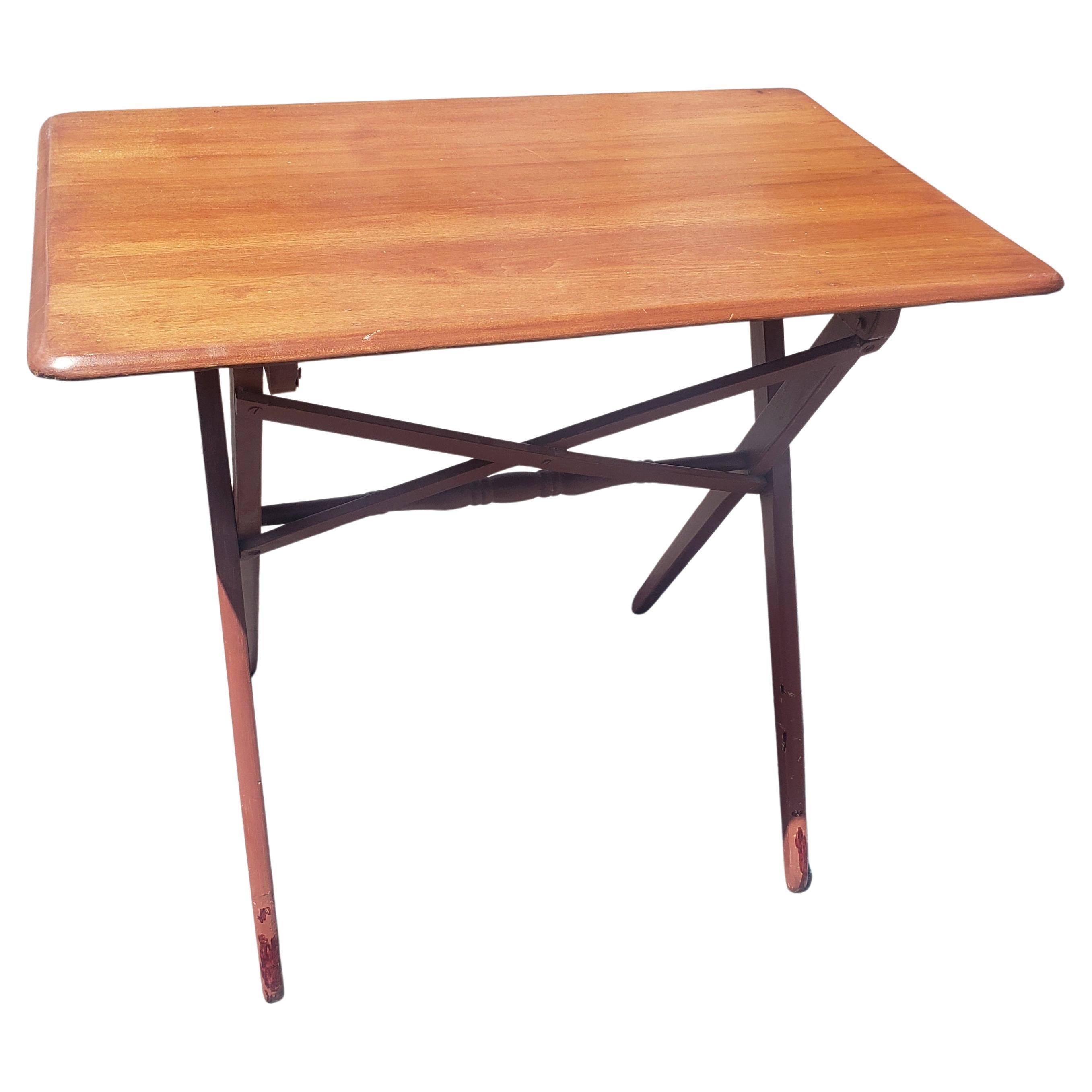 A Mid-Century Stained Maple Adjustable Height Folding Table

Measures 30