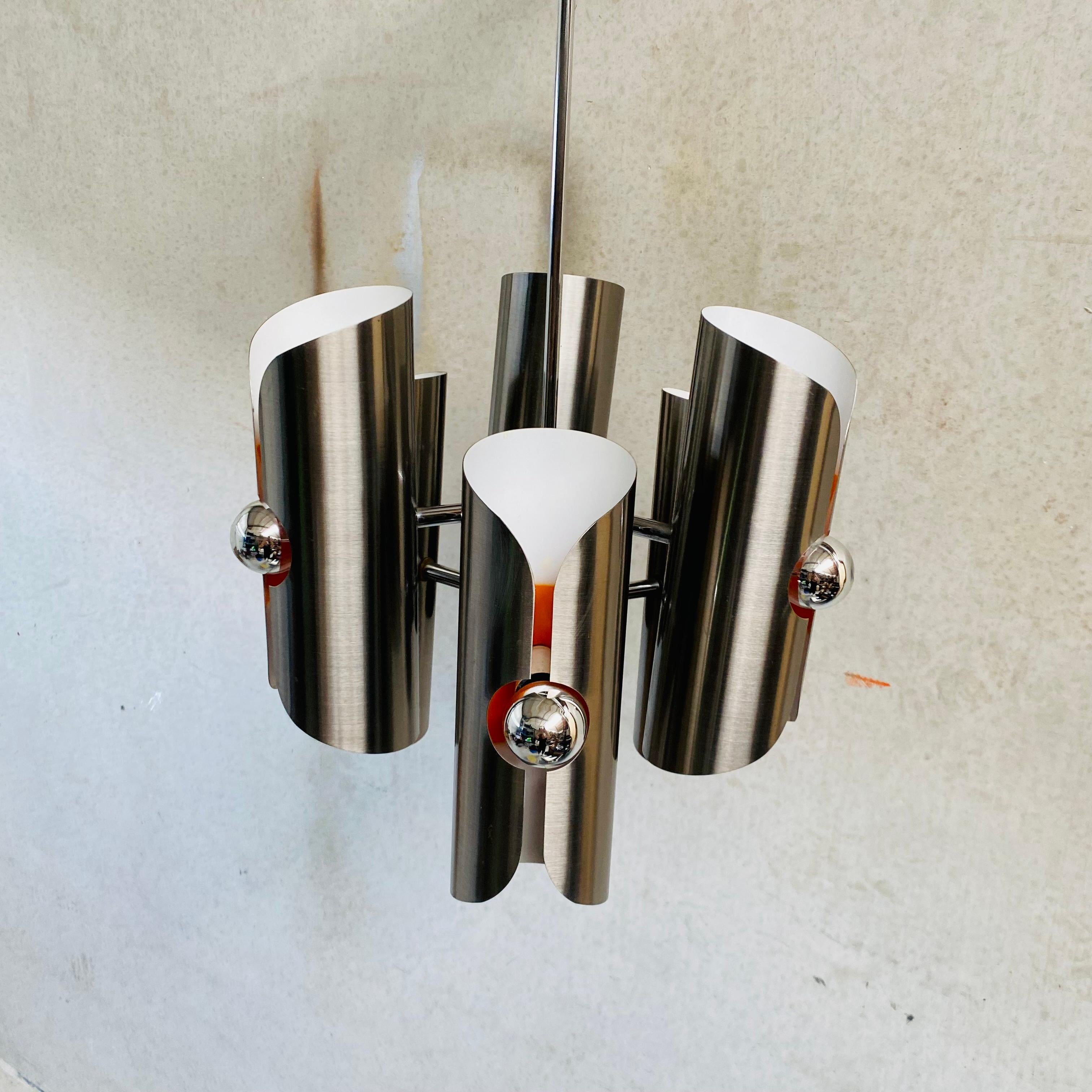 Polam Chandelier: A Timeless Statement Piece 1970

Transport yourself back to the glamorous 1970s with this captivating chandelier from Polam. Crafted with a sleek chrome frame, it exudes a distinctive charm that's perfect for elevating your