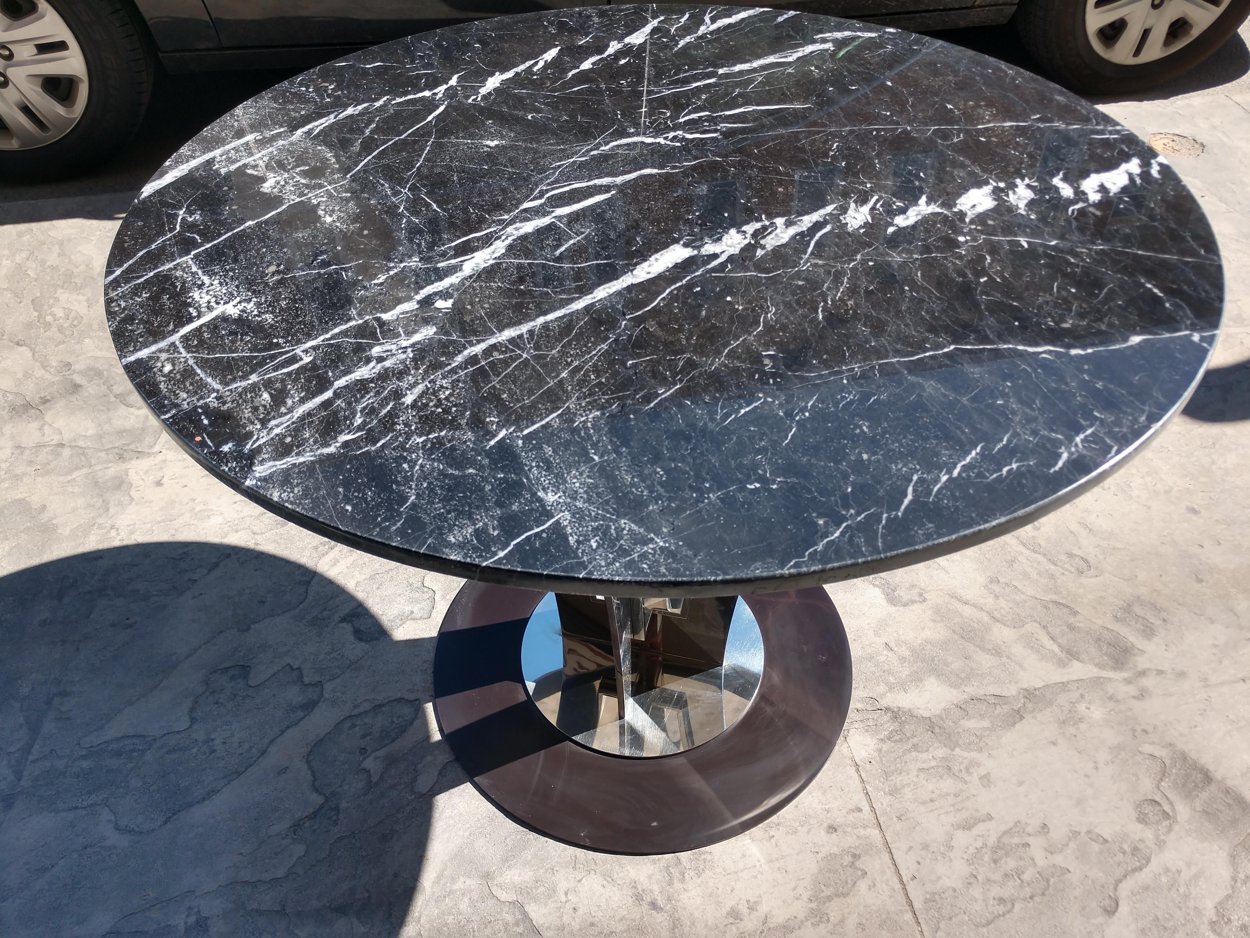 Fabulous table from his Manhattan flagship store. Table was upgraded with a great piece of black marble with stunning white veins running throughout. In excellent vintage condition with minimal wear.