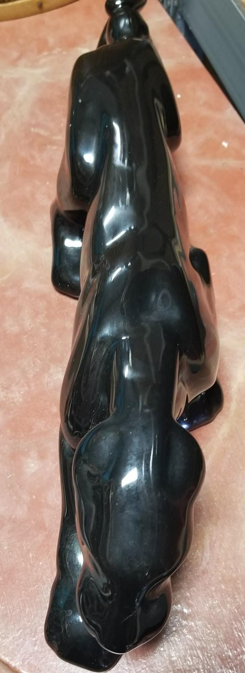 The stalking panther theme was one of the most popular subjects for Mid-Century TV Lamps and other decorative porcelain objects d'arte. This piece is a stand-alone statuette, finished in a high-gloss black glaze. It's slender enough to prowl happily