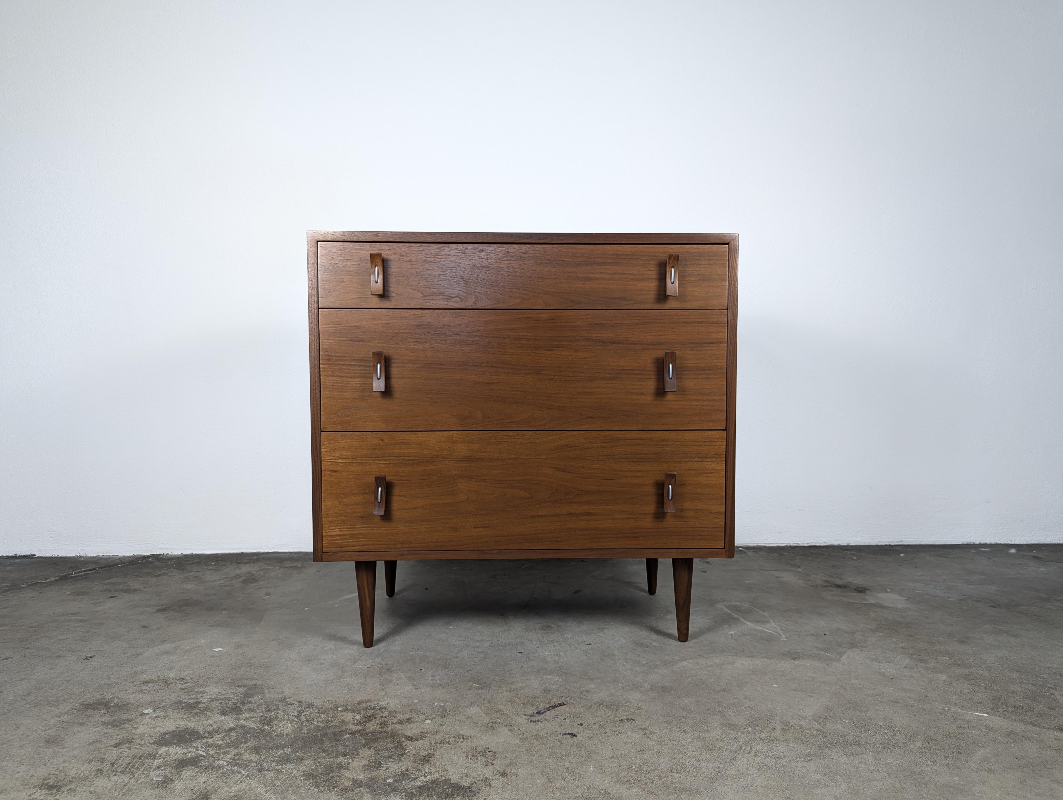 Step into the timeless elegance of mid-century modern design with this exquisite vintage 3-drawer chest/dresser, a masterpiece crafted by the renowned Stanley Young for Glenn of California, circa 1950s. This iconic piece features sculptural solid