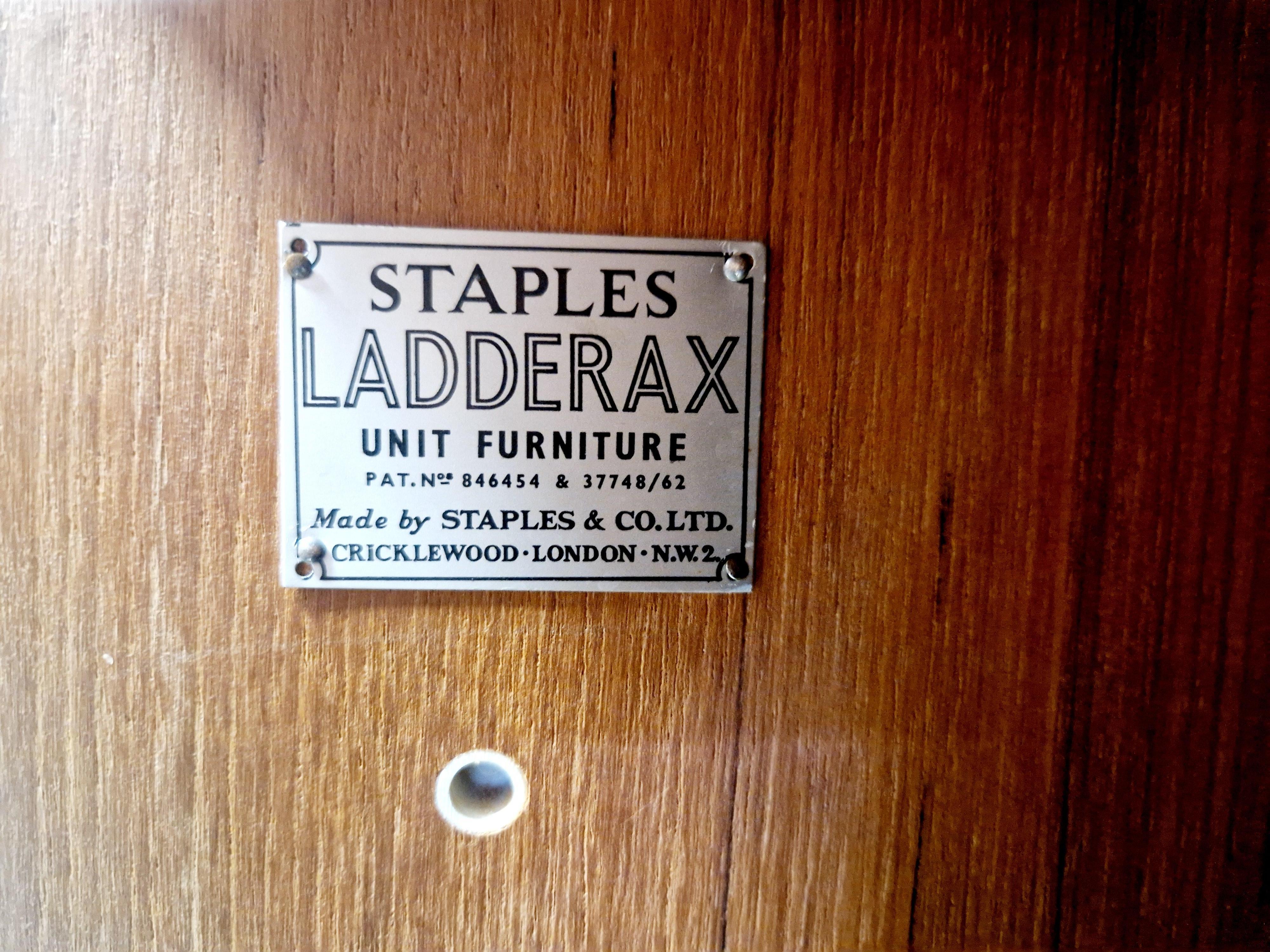 Explore the charm of vintage furniture with this Mid Century Staples Ladderax Shelving Cupboard By Robert Heal , a stunning piece dating back to 1964. Crafted with a blend of wood and metal, this cupboard boasts a timeless design, complete with two