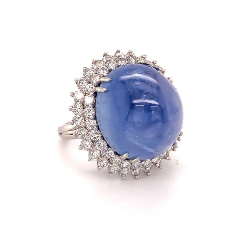 One mid-century star sapphire and diamond platinum ring featuring one oval cabochon, star sapphire weighing 40 ct. surrounded by 56 round brilliant cut diamonds weighing 2 ct. Sapphire holds significant height and depth with gorgeous depth of color.