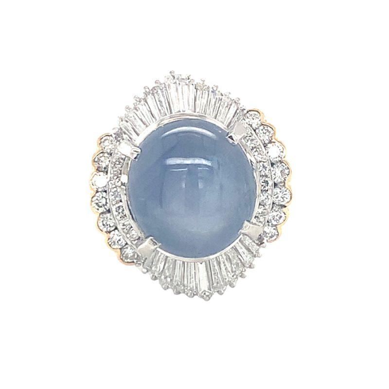 Star sapphire and diamond ring set in platinum and 18K yellow gold featuring one round cabochon, blue star sapphire weighing 20 ct. with fifty-six tapered baguette and round diamonds weighing 2 ct., G-H color and SI-1 clarity.

Bold, dazzling,