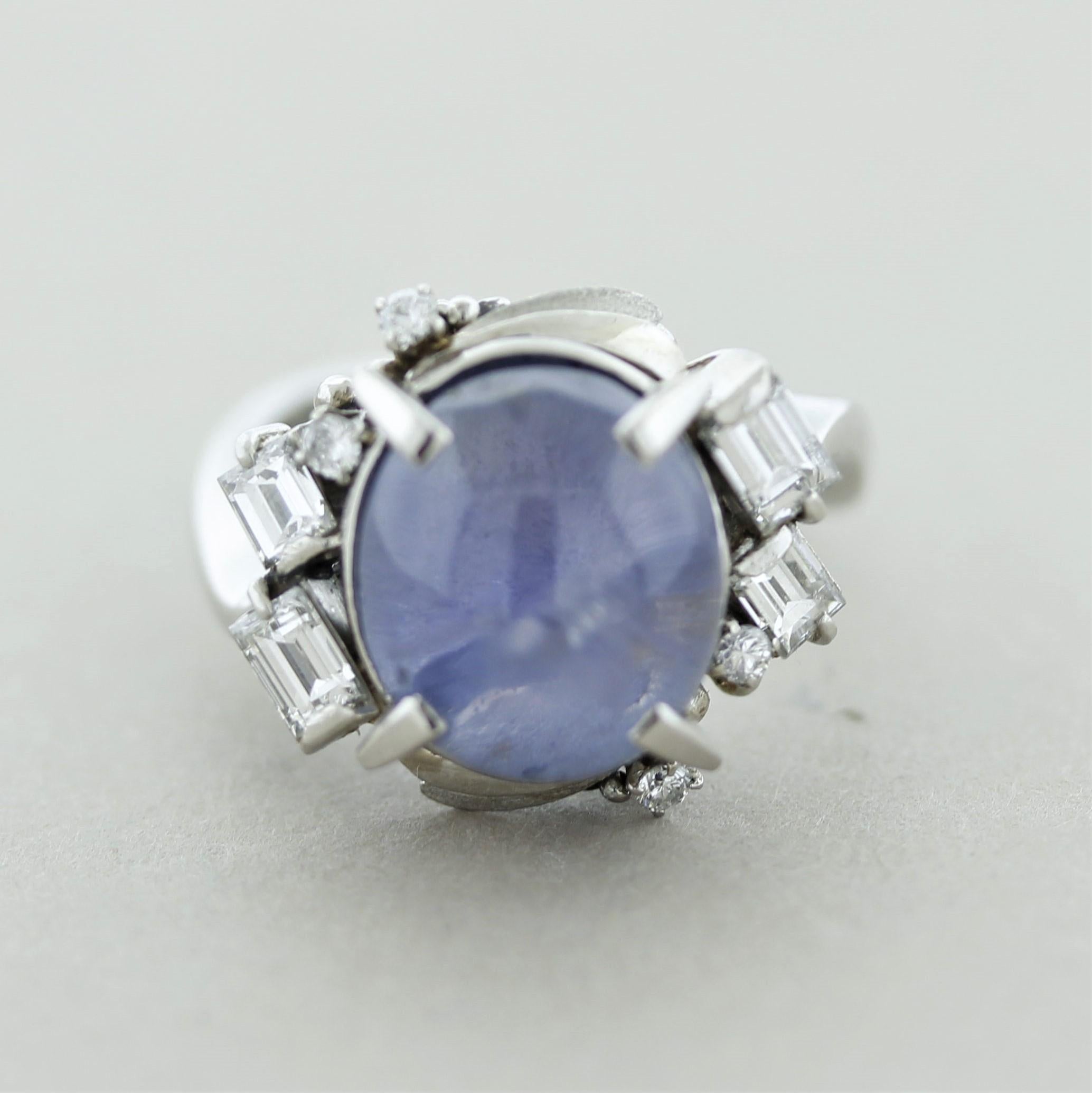 A dazzling mid-century ring, circa 1960’s. It features a 9.35 carat star sapphire with excellent transparency, your eyes will get lost inside the stone. Accenting the sapphire are 4 large chunky baguette-cut diamonds along with 4 round brilliants,