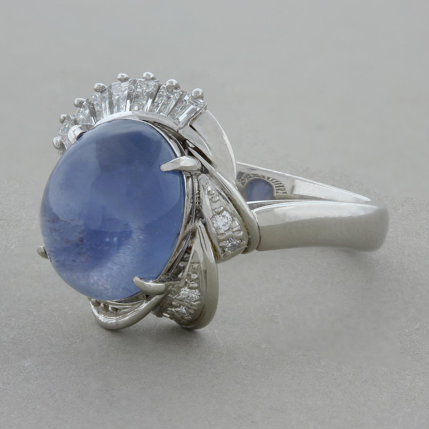 A dazzling platinum ring featuring a 7.64 carat cabochon star sapphire, circa 1960. The blue star sapphire is accented by a platinum twisting halo of 0.36 carats of round and baguette cut diamonds.  

Ring Size 6.75 (Sizable)
