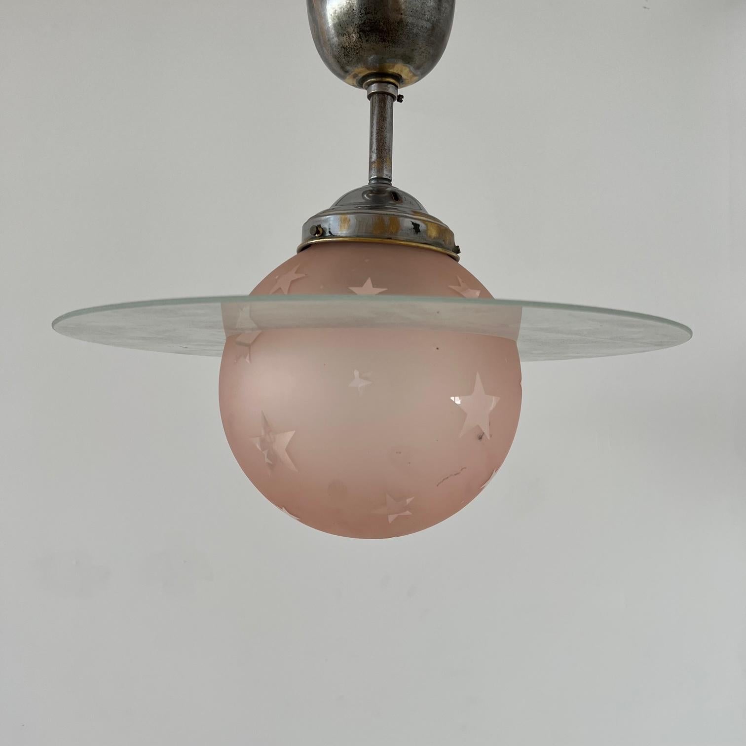A stylish two tone pendant light. 

France, c1960s. 

The saturn style glass rim sits on top of the glass globe, so it is optional. 

Since re-wired and PAT tested. 

Rod Height: 33cm

Location: Belgium Gallery. 

Dimensions: 84 H x 36 W