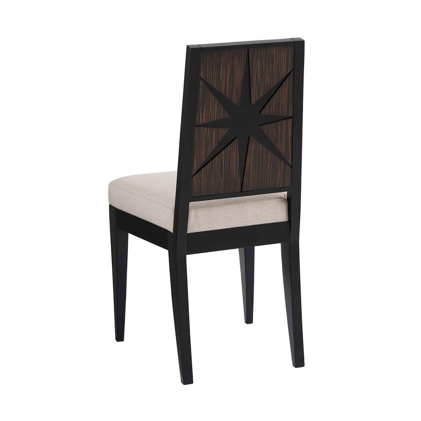 Midcentury side chair with ebonized beechwood, cut star relief back with simulated ebony veneers, an upholstered cushion seat and square tapered sabre legs.

Dimensions: 17