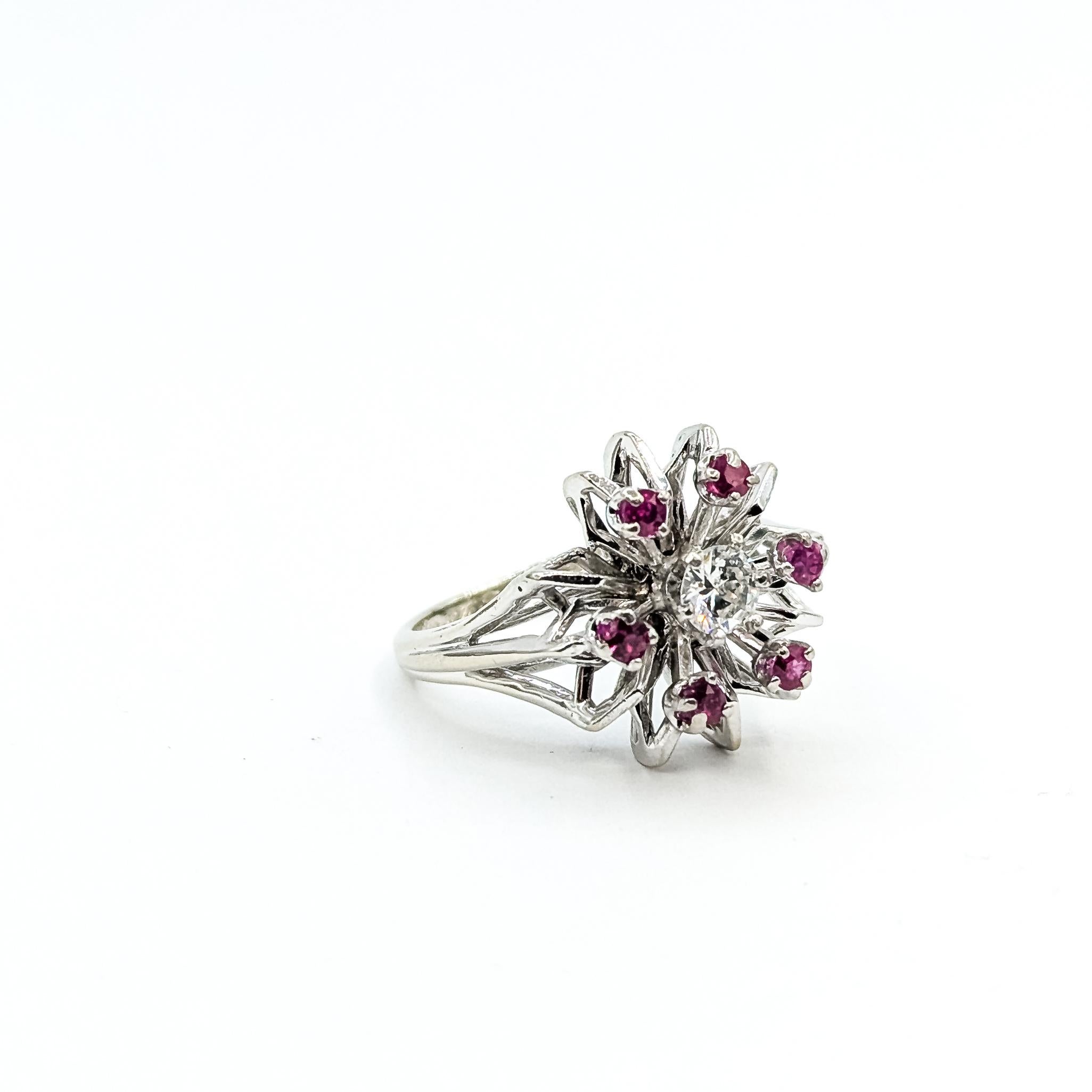 Mid-century Starburst Ruby 
Diamond Ring in 14k

This ring is crafted in 14k white gold and features prong-set rubies in a striking starburst design, a true example of the Mid-century era. The rubies total approximately 0.20ctw. At the center