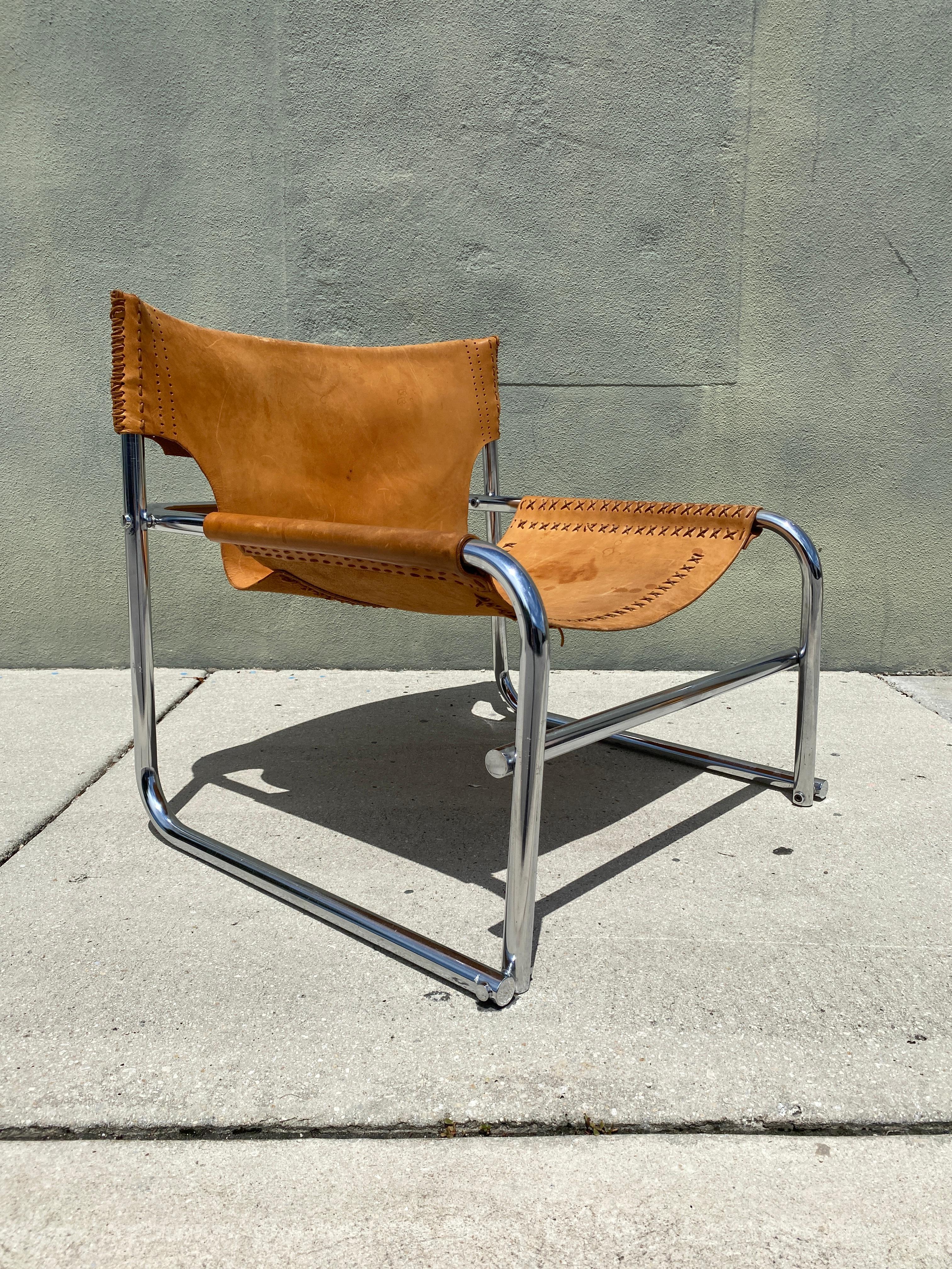 Vintage Armchair in Tubular steel and leather designed by Rodney Kinsman in the UK, 1960s for his company OMK . Clean sturdy and sound, brown leather has no rips or tears, only some marks that add aging character to the piece.

Measures: 31.5” W x