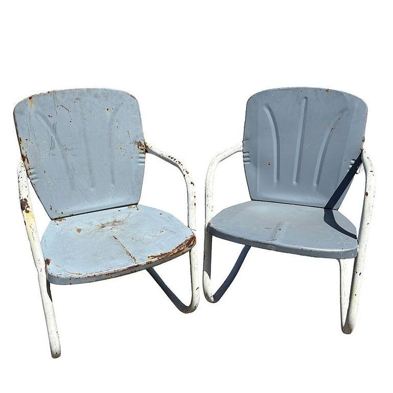 Steel Mid-century Springer Outdoor grey enamel Lounge Chair Set of Two. Each chair features a white round tubular U-shaped base that rocks and forth when pushed back and forth. The chair features a Flat Iron style pressed steel seat back with a