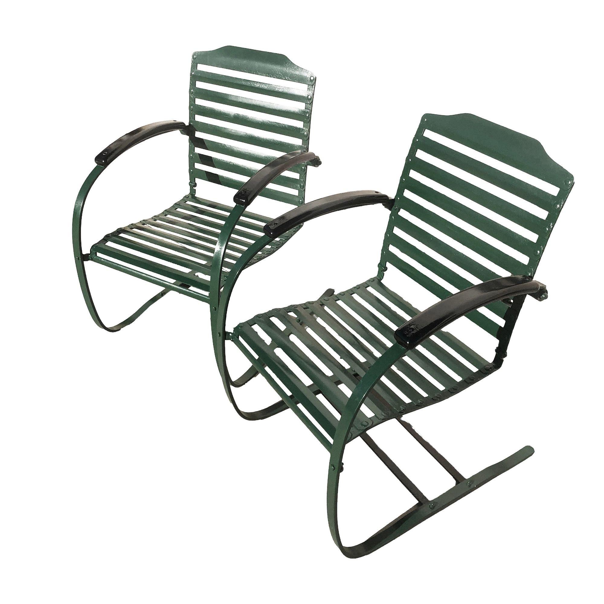 Enjoy the serene beauty of your outdoor space with this pair of elegant dark Forest Green cantilever Springer Garden chairs. This vintage patio chair pair features sturdy metal construction with a horizontal slat seat and back. Rounded cantilever