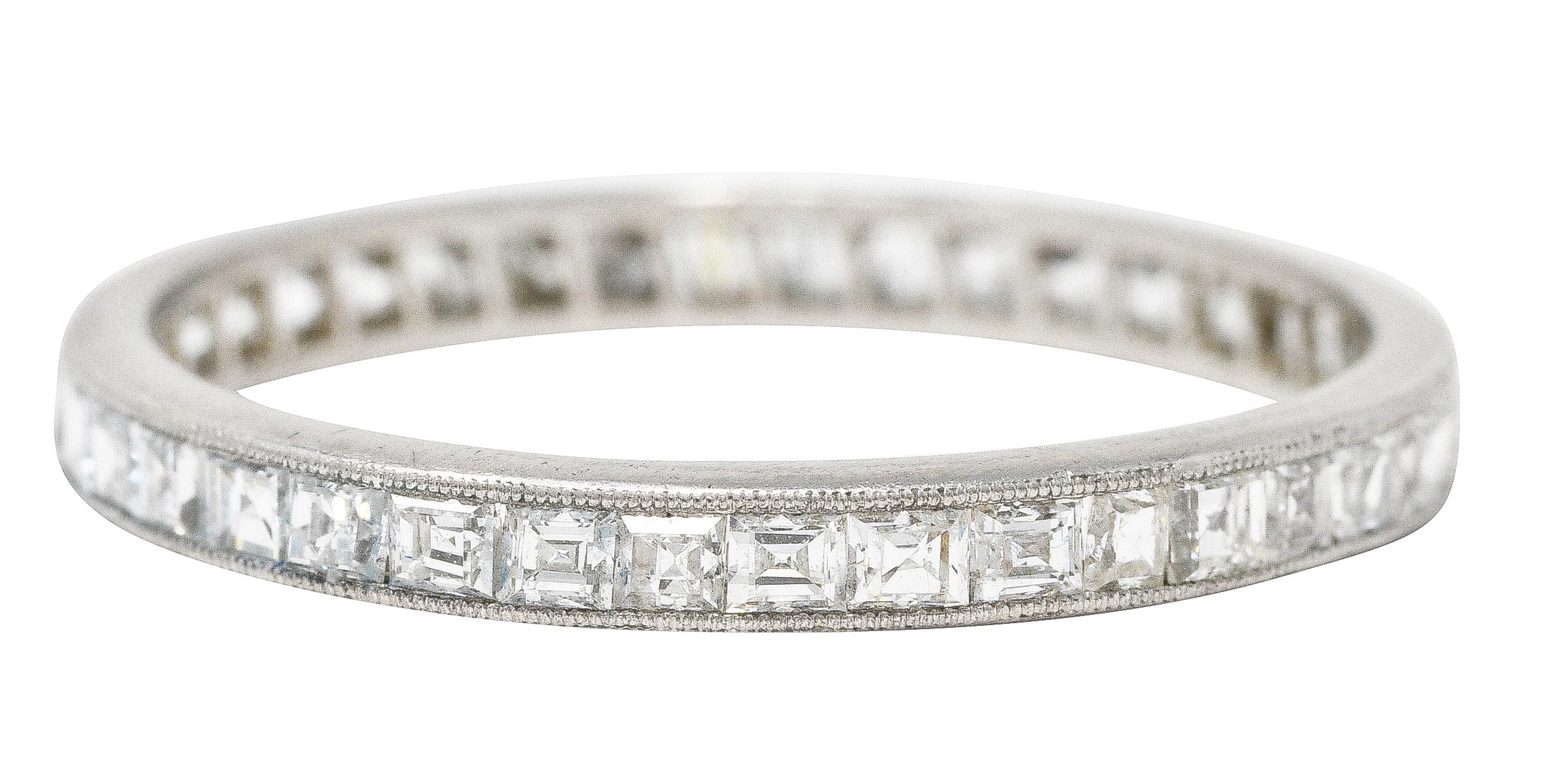 Band ring features square step cut diamonds channel set to front. Weighing approximately 1.00 carat total - F/G in color with VS1 clarity. With milgrain edge surround. Tested as platinum. Circa: 1950's. Ring size: 7 1/2 and not sizable. Measures: