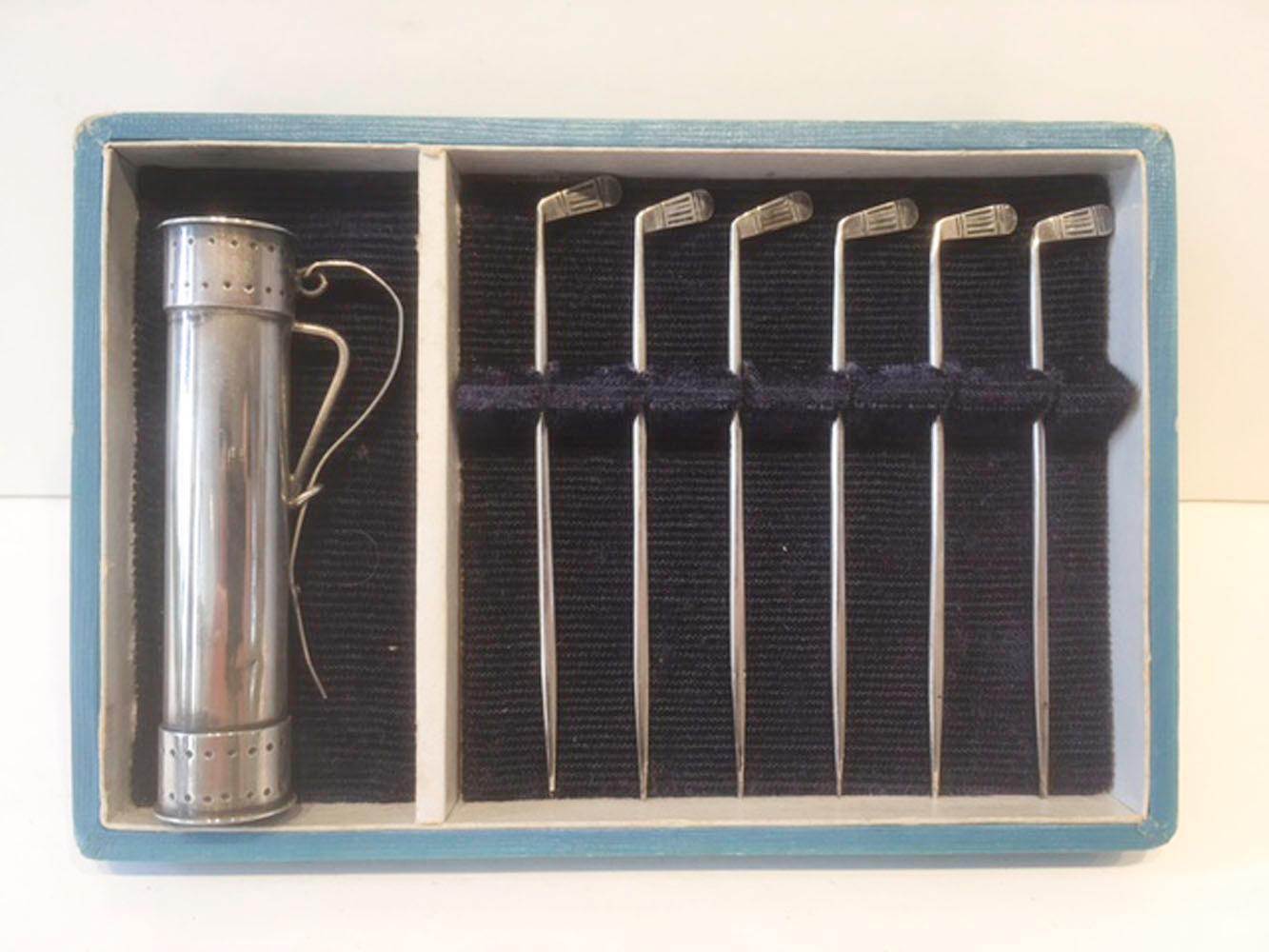 Set of 6 cocktail picks in the form of golf clubs with a golf bag form holder. The golf bag is marked Sterling 950 on the bottom. The set comes in its original fitted box (box shows wear).