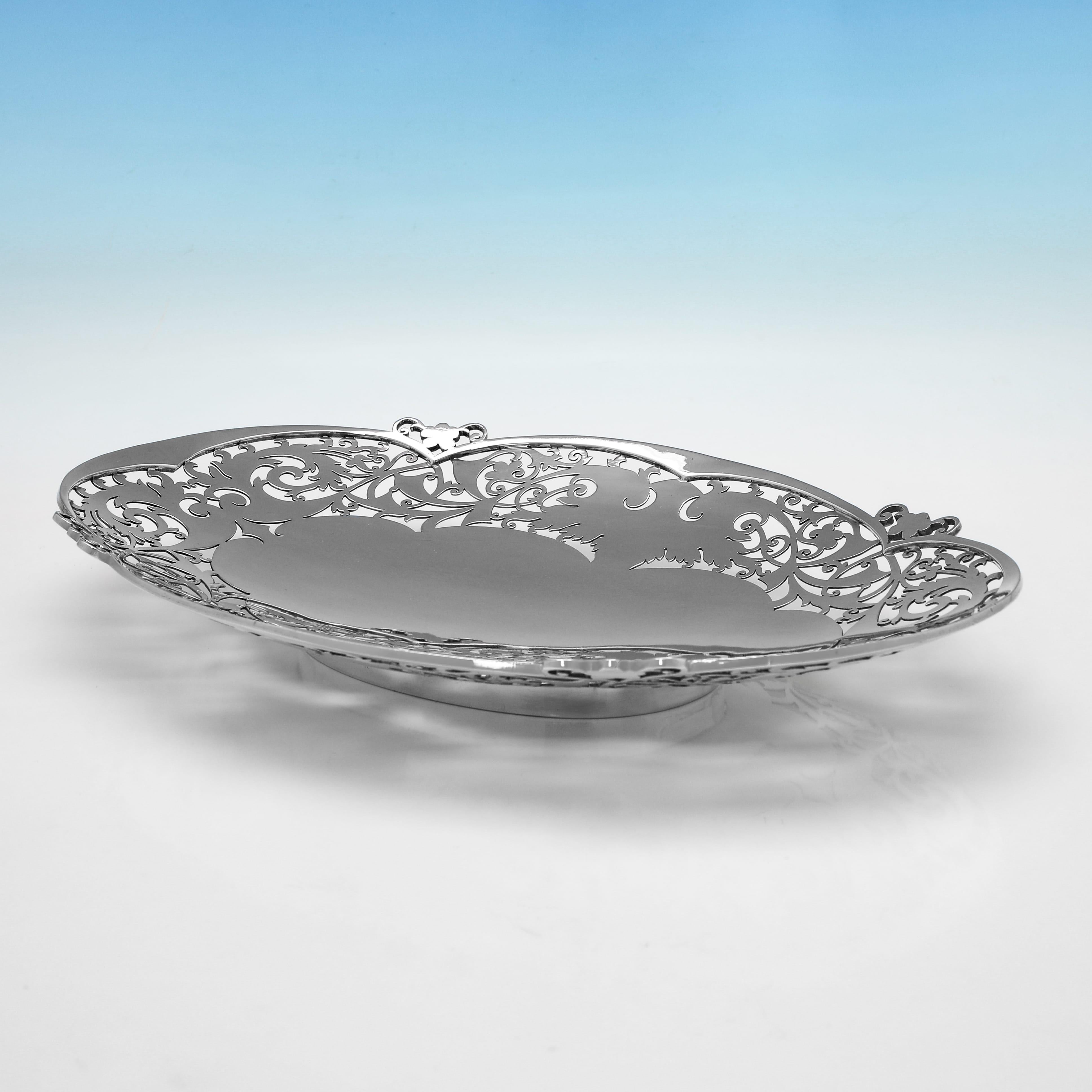 Hallmarked in Sheffield in 1956 by Walker & Hall, this attractive, Sterling Silver Dish, features pierced decoration to the sides, and is otherwise plain in style. The dish measures 1.5