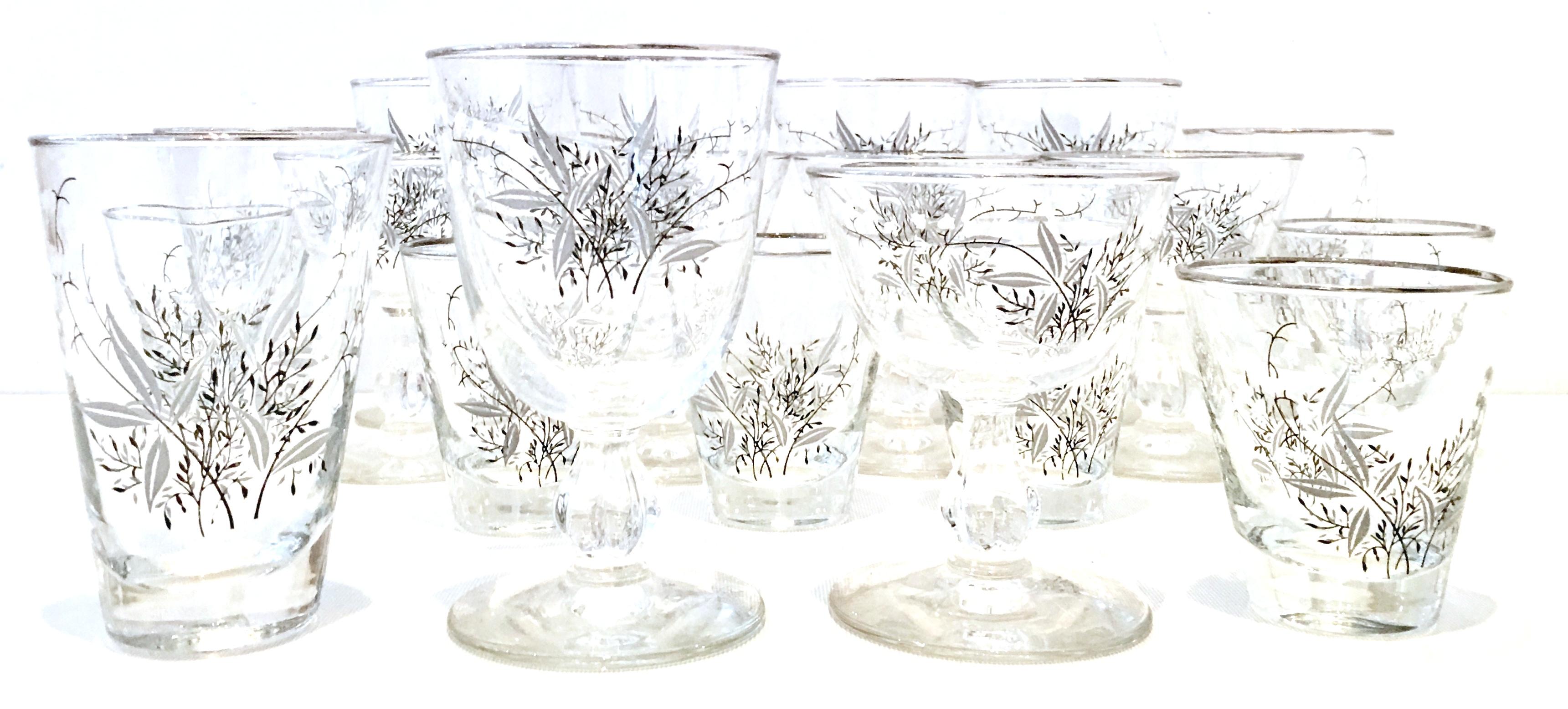 Mid-Century Modern sterling silver and embossed floral motif glass drinks set of 19 pieces. The embossed and printed pattern features a sterling silver rim with black, white and grey floral motif. Set includes, six cocktail glasses, five coupe stem