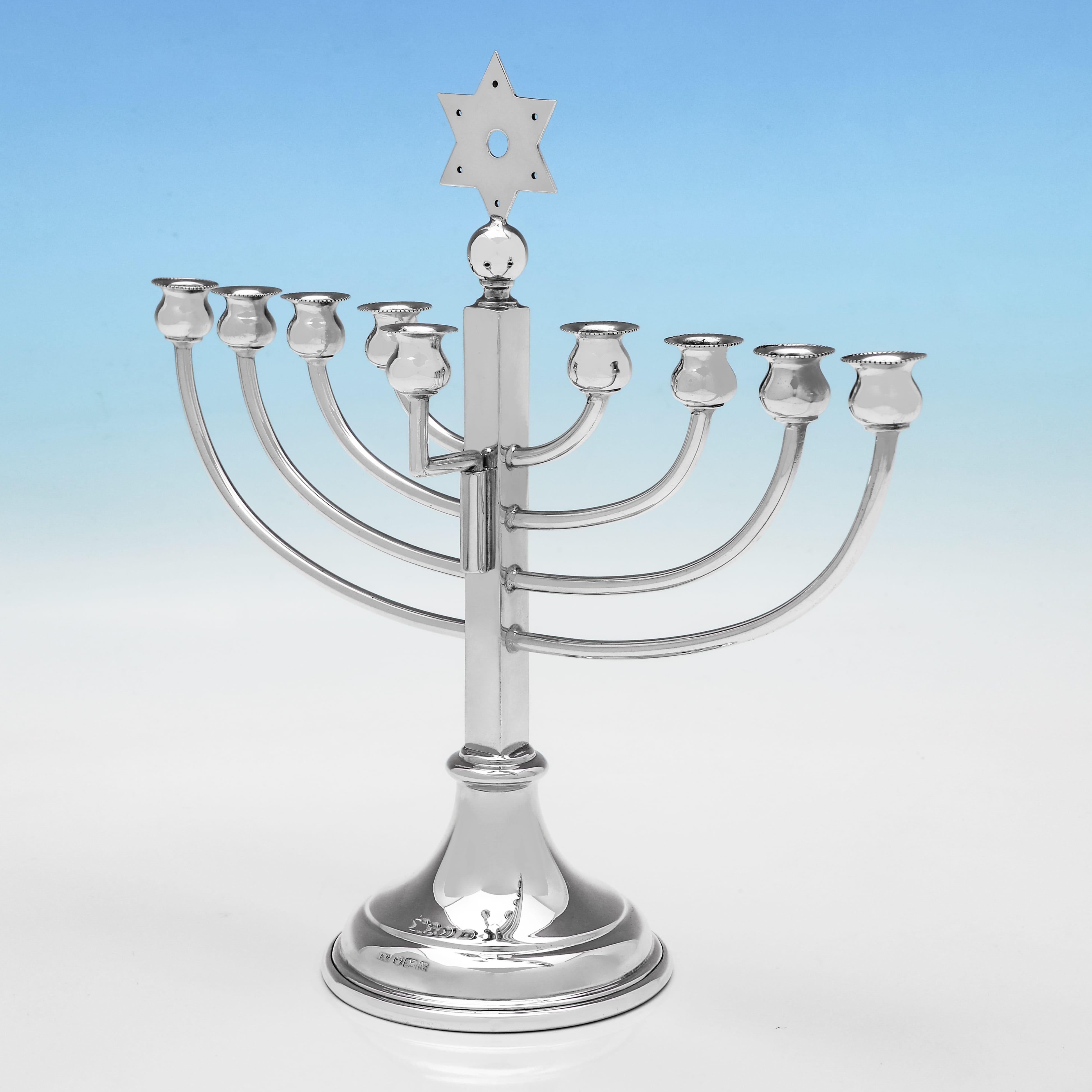 Hallmarked in Sheffield in 1954 by Viner's Ltd., this handsome Elizabeth II period, Sterling Silver Menorah, is of traditional form. The menorah measures 9.75