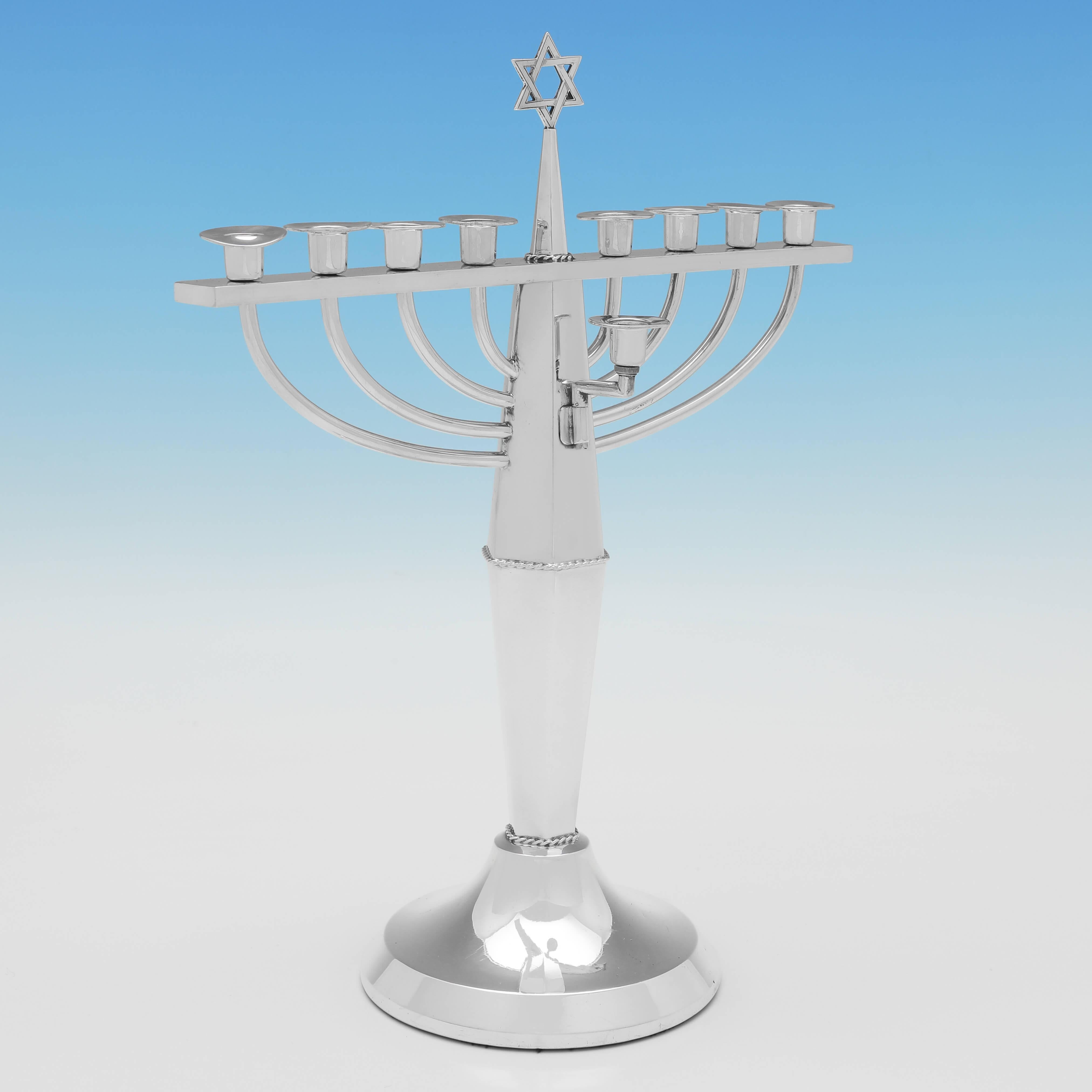 Hallmarked in Birmingham in 1950 by Bishtons Ltd., this stylish, Sterling Silver Menorah, is hexagonal in shape, and plain in style. The menorah measures 11.5