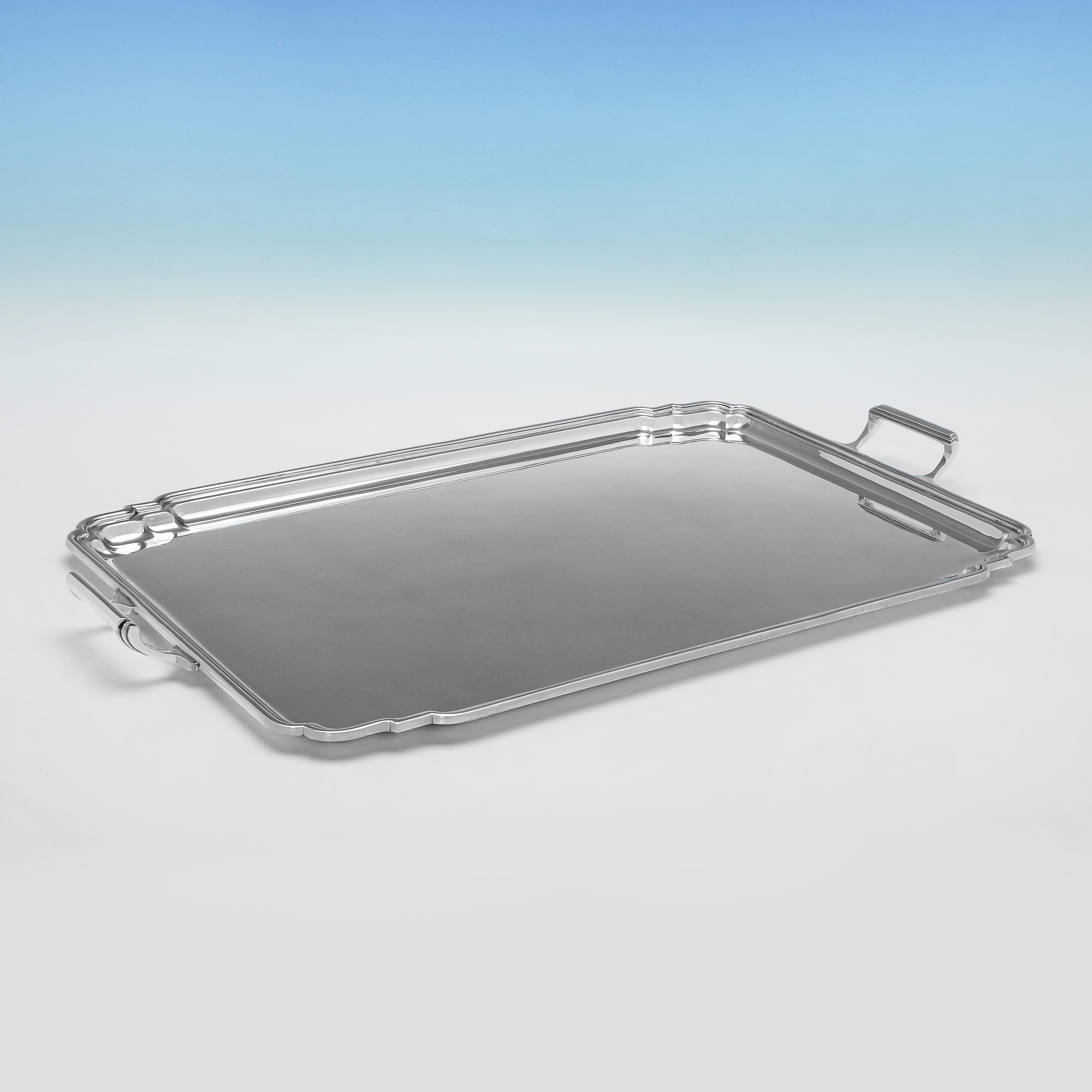 Hallmarked in Sheffield in 1959 by Mappin & Webb, this stylish, Elizabeth II period, Sterling Silver Tray, is plain in design, with shaped corners, and reed detailing throughout. The tray measures 1.5