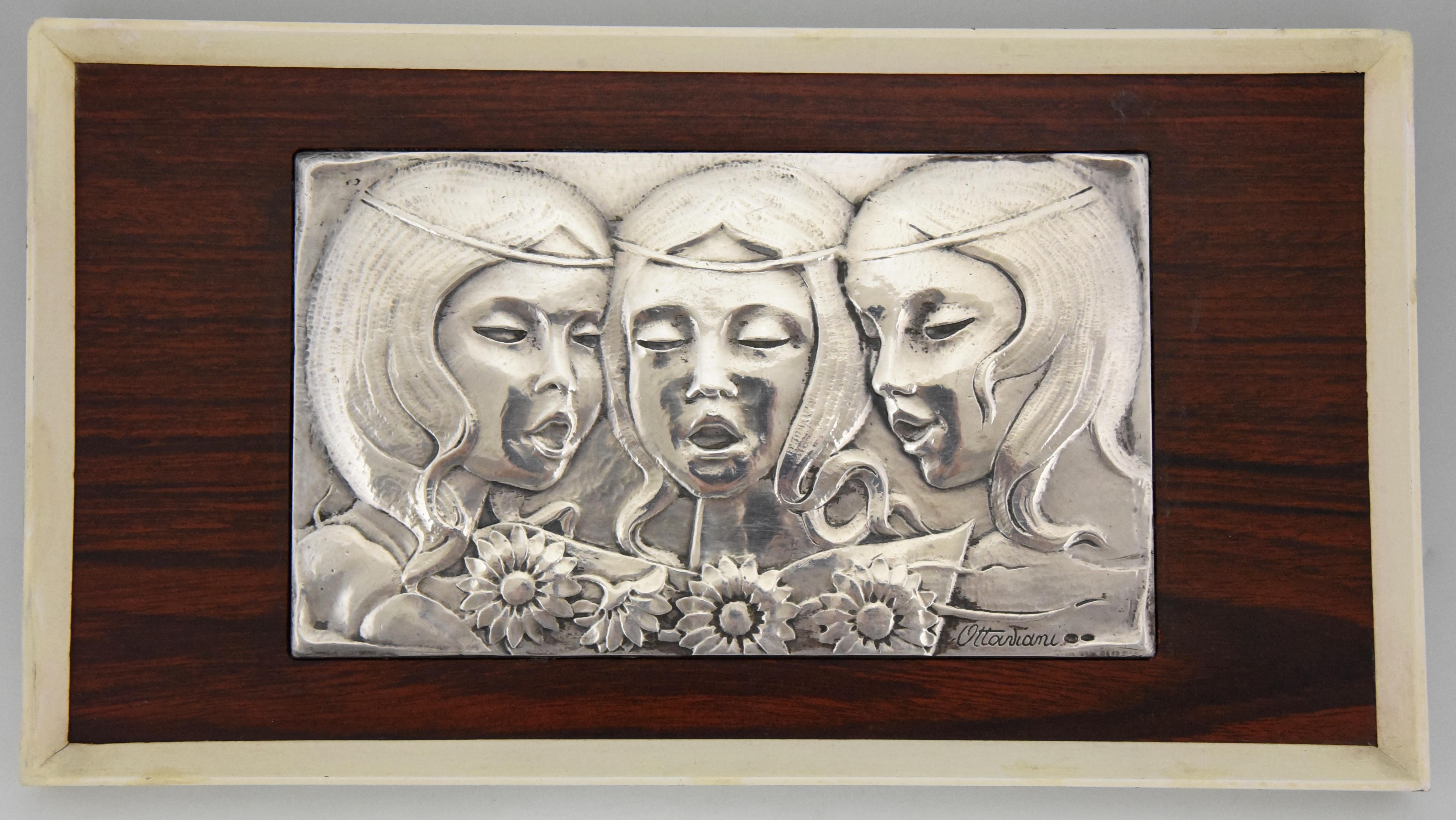 Lovely Mid Century Sterling silver wall panel 3 singing girls with flowers. Signed by the Italian silversmith Ottaviani, 1960. 
Ottaviani (1945) is a jewelry and silver firm located in the small seaside town of Recanati, Italy. They had a