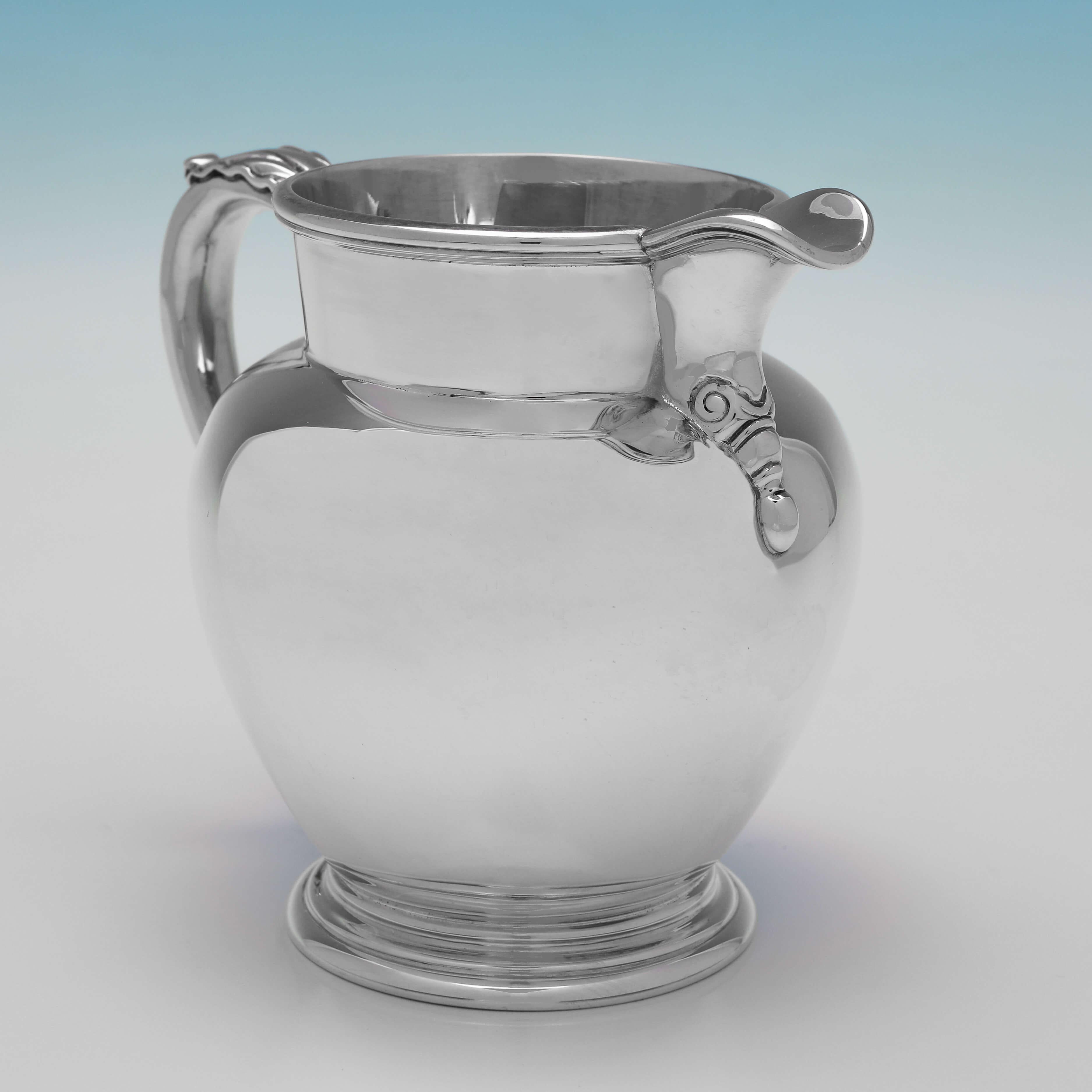 Hallmarked in Sheffield in 1979 by Roberts & Belk, this handsome, Sterling Silver Water Jug, is of traditional design, with reed detailing and an acanthus leaf decorated handle. 

The water jug measures 4.75