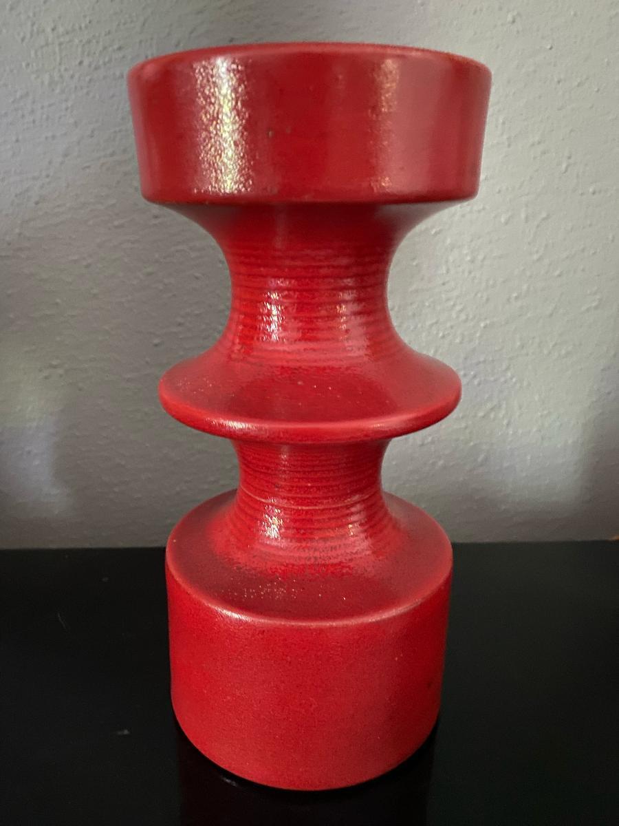 One beautiful, in a stunning red glaze, candleholder from the designer Cari Zalloni for Steuler Keramik. The candle holder are signed on the base with the company’s trademark and model number.
Steuler was founded by Georg Steuler in